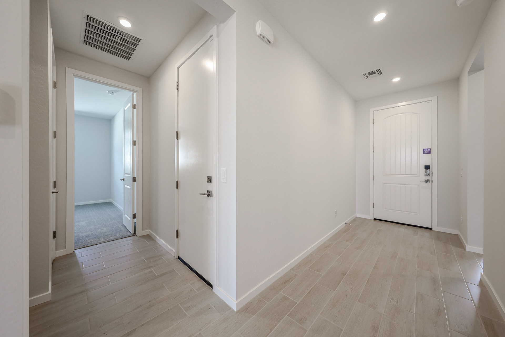A hallway with white doors.