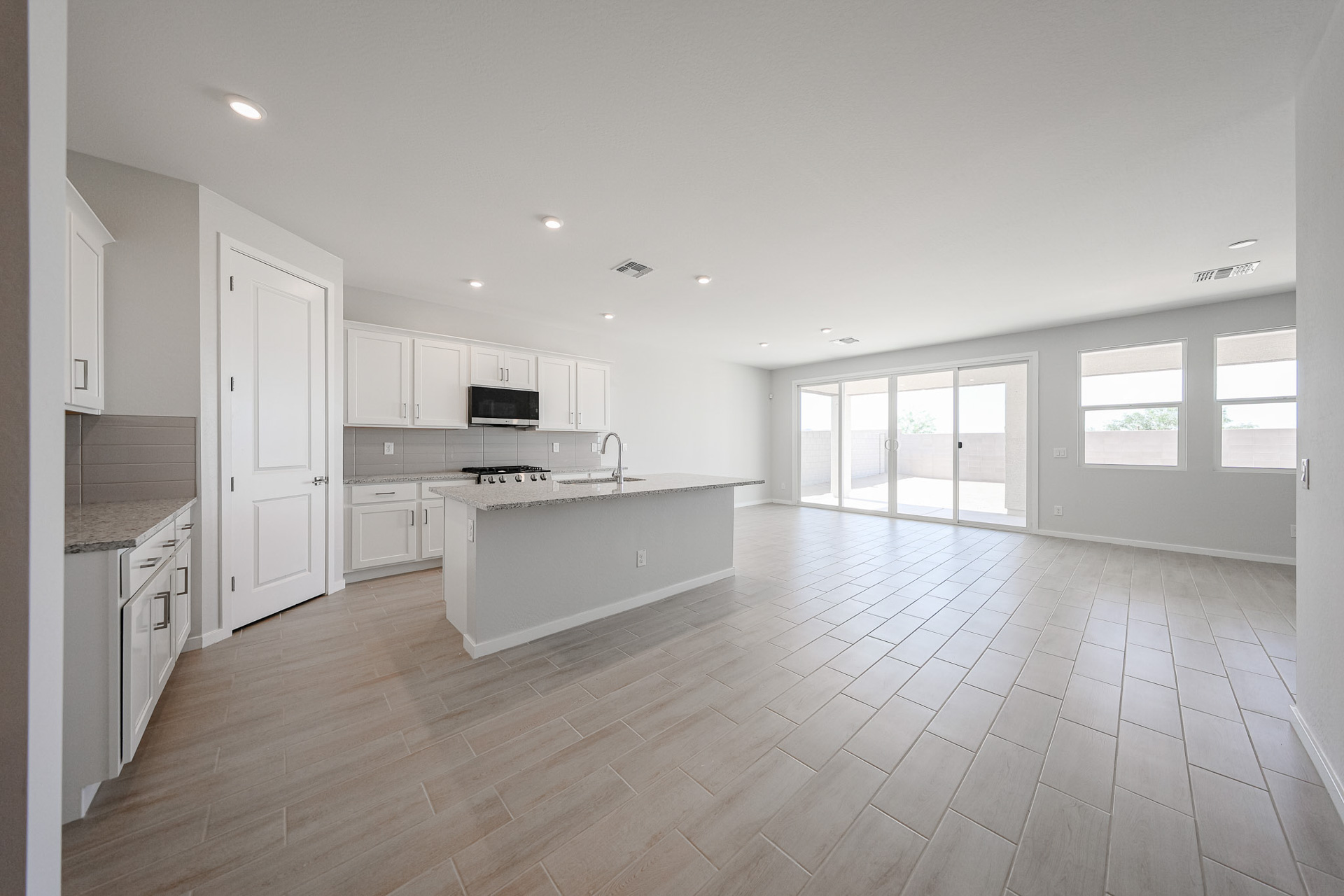 A large kitchen with white cabinets.