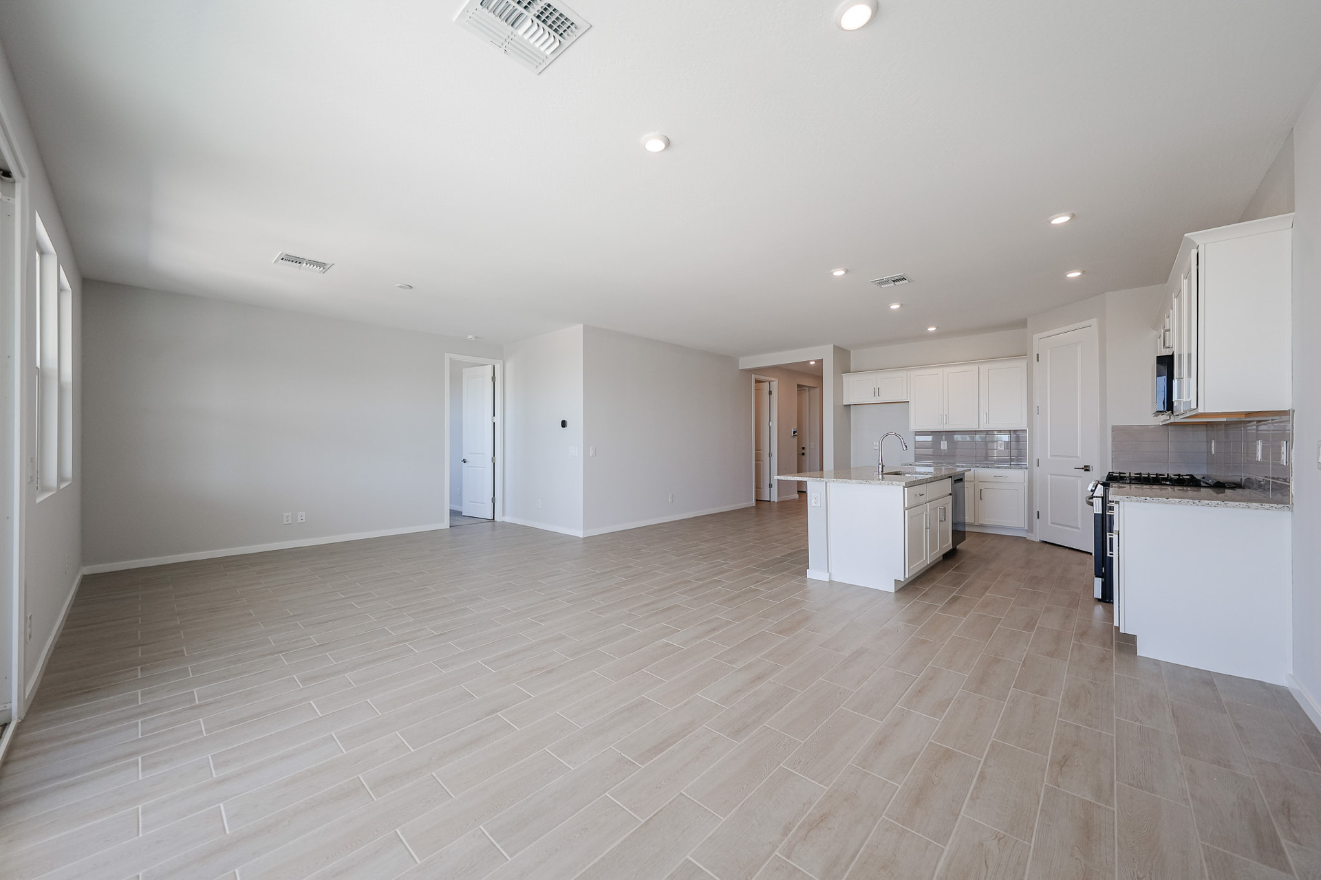 A large kitchen with white cabinets.