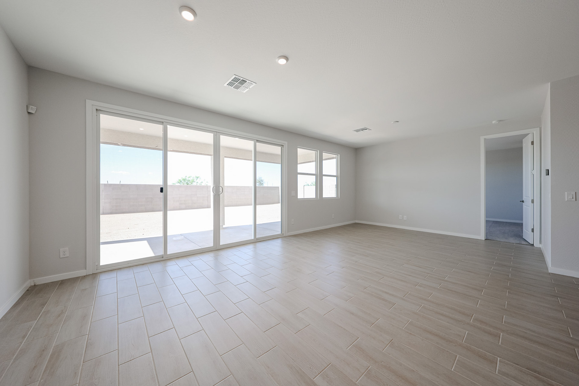 A room with a wood floor and white walls.