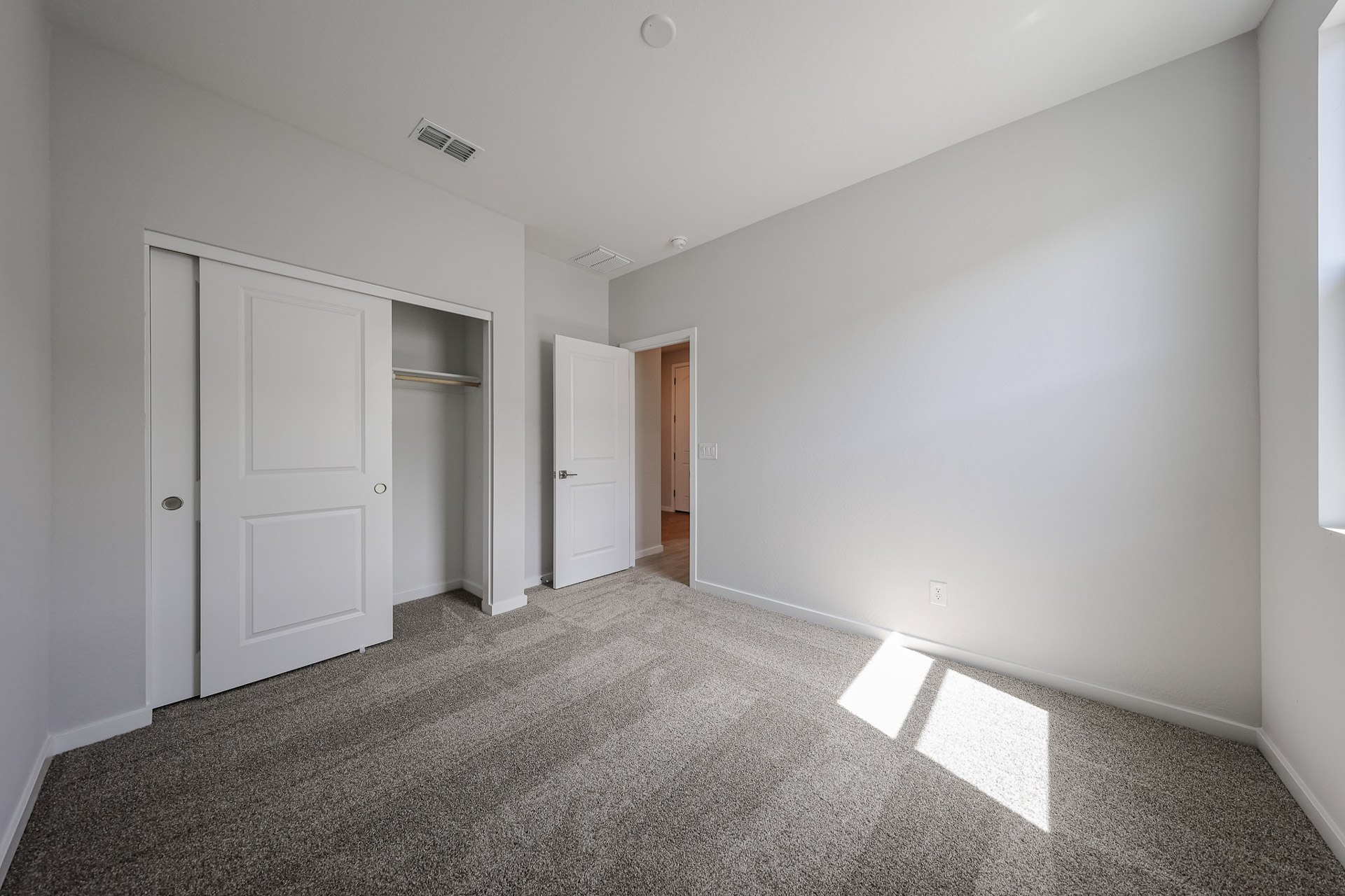 A hallway with white doors.
