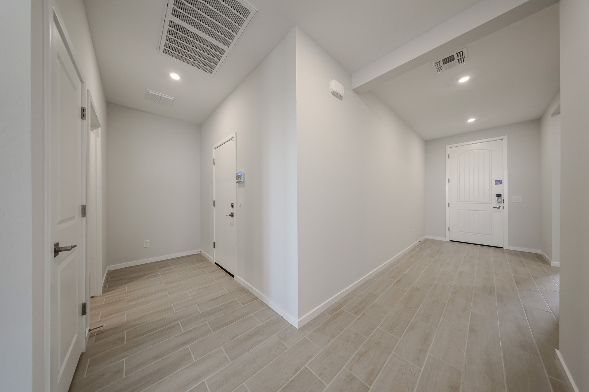 A hallway with white doors.