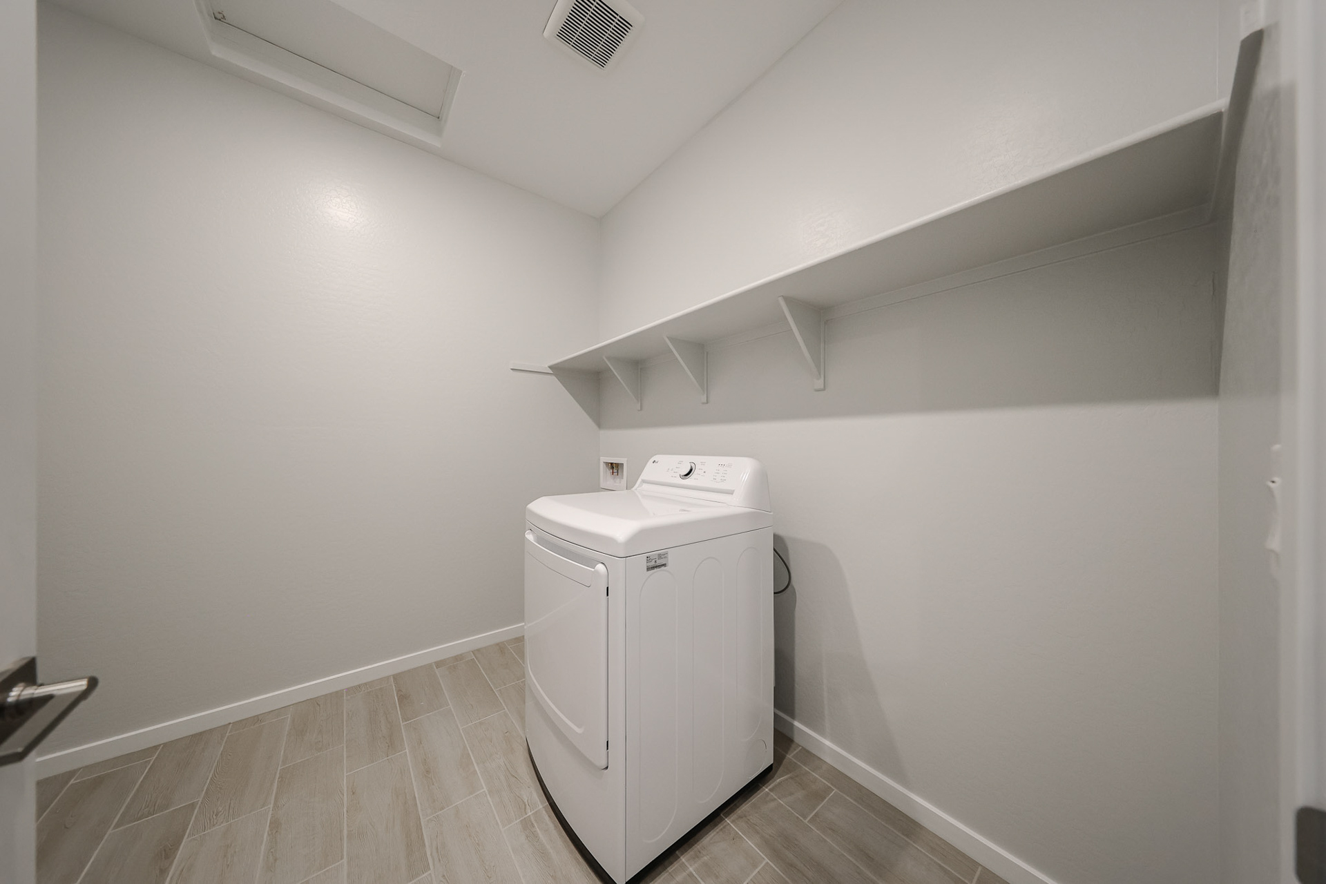 A white washing machine in a room.