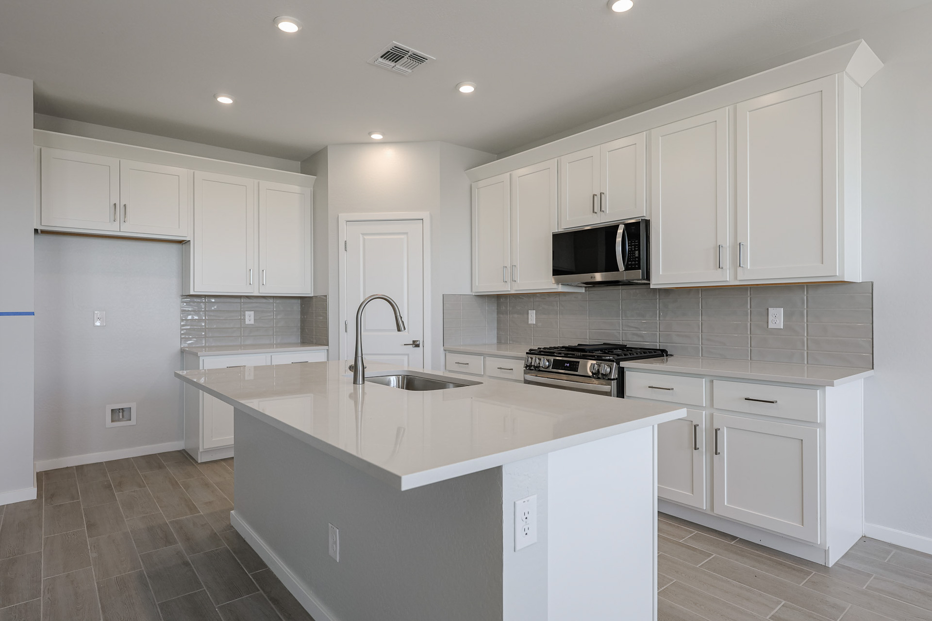A kitchen with white cabinets.