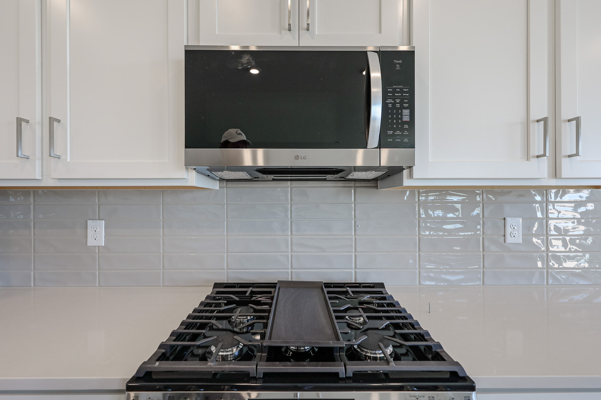 A kitchen with a microwave oven and a stove.