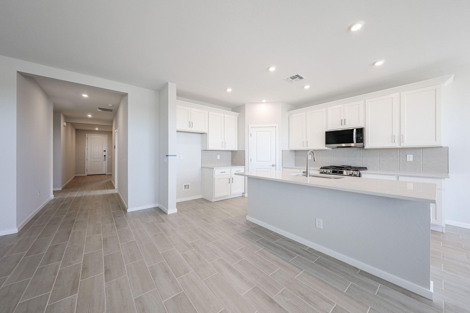 A kitchen with white cabinets.