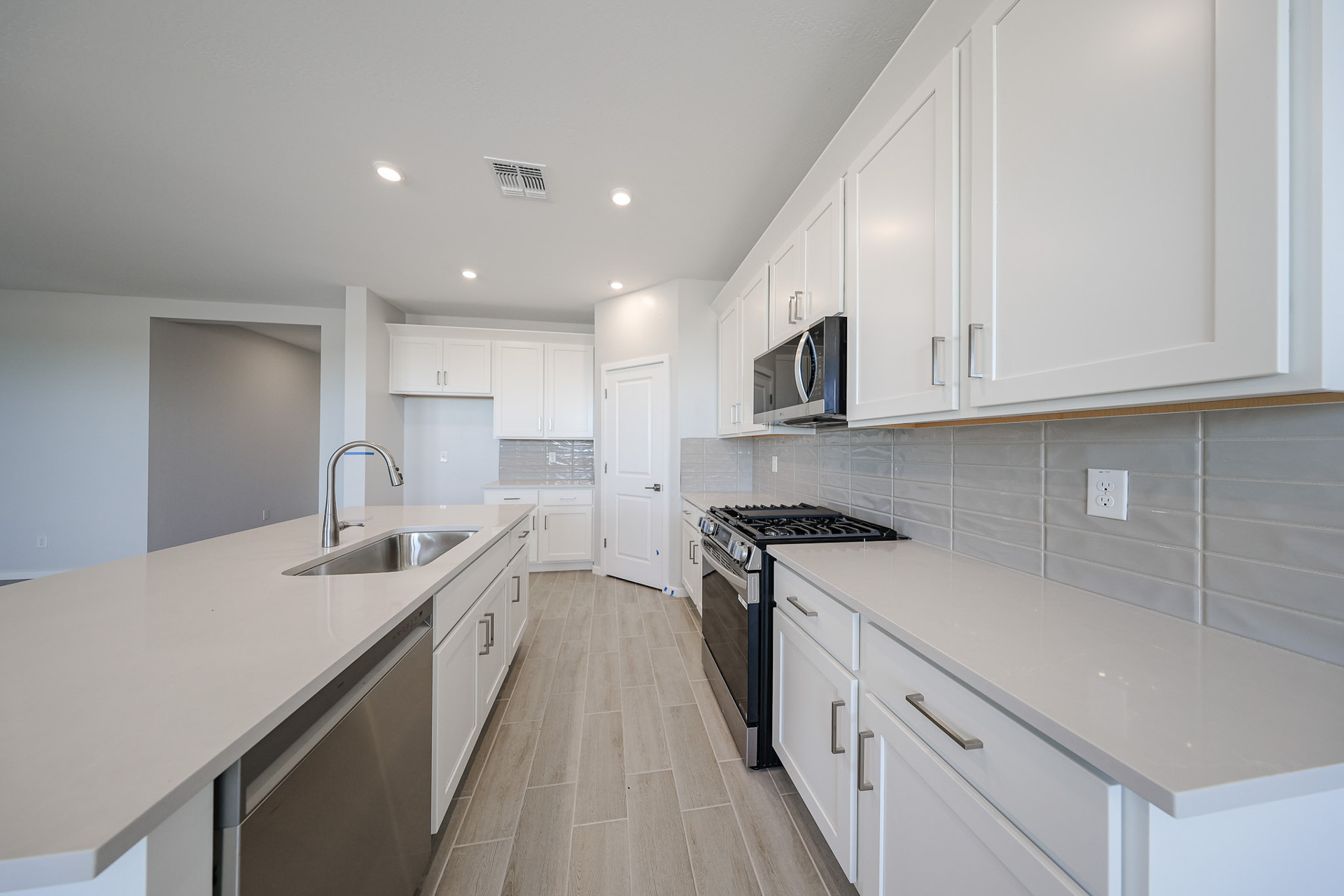 A kitchen with white cabinets.
