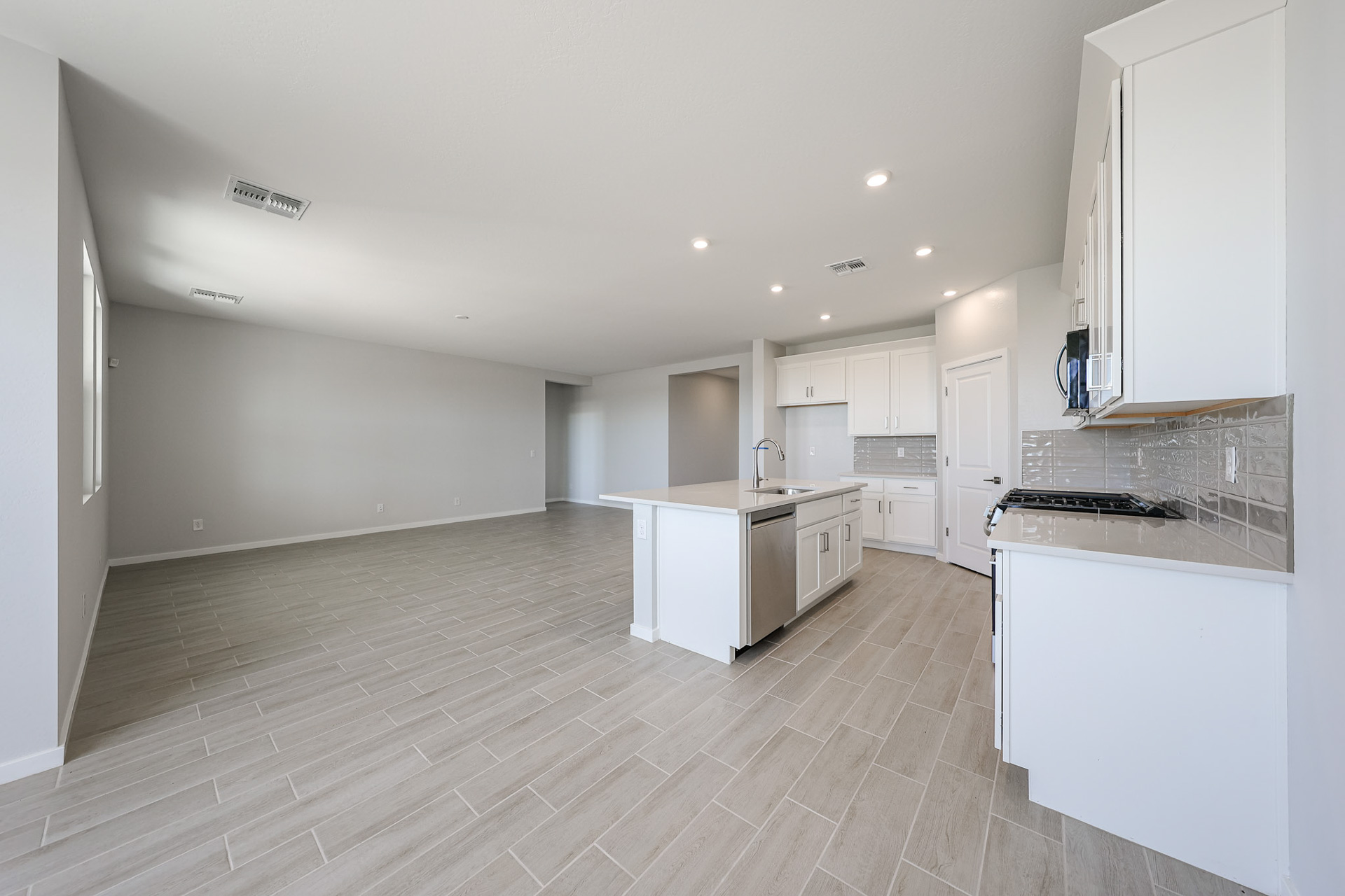 A kitchen with white cabinets.