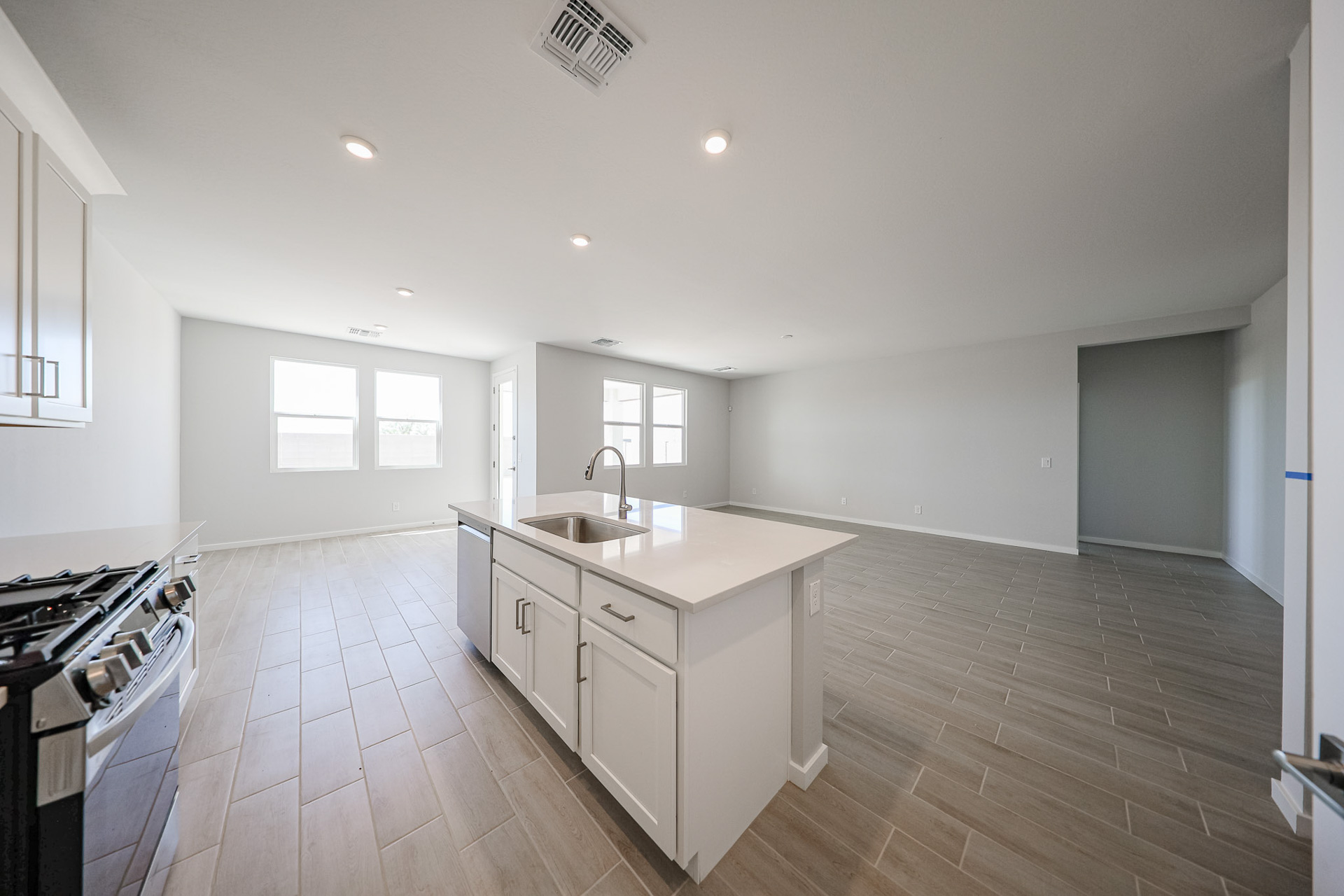 A kitchen with white cabinets.