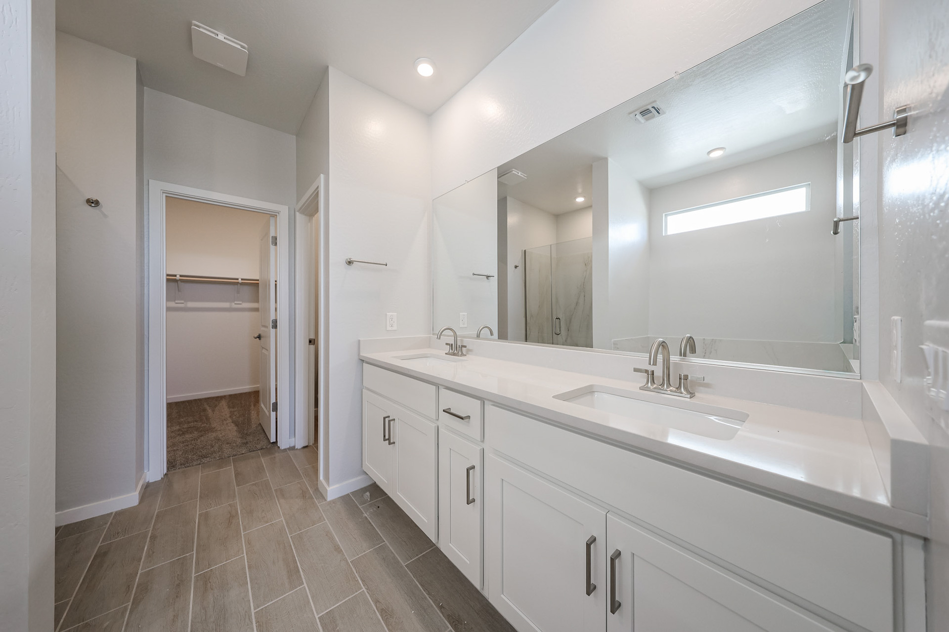 A bathroom with a large mirror.