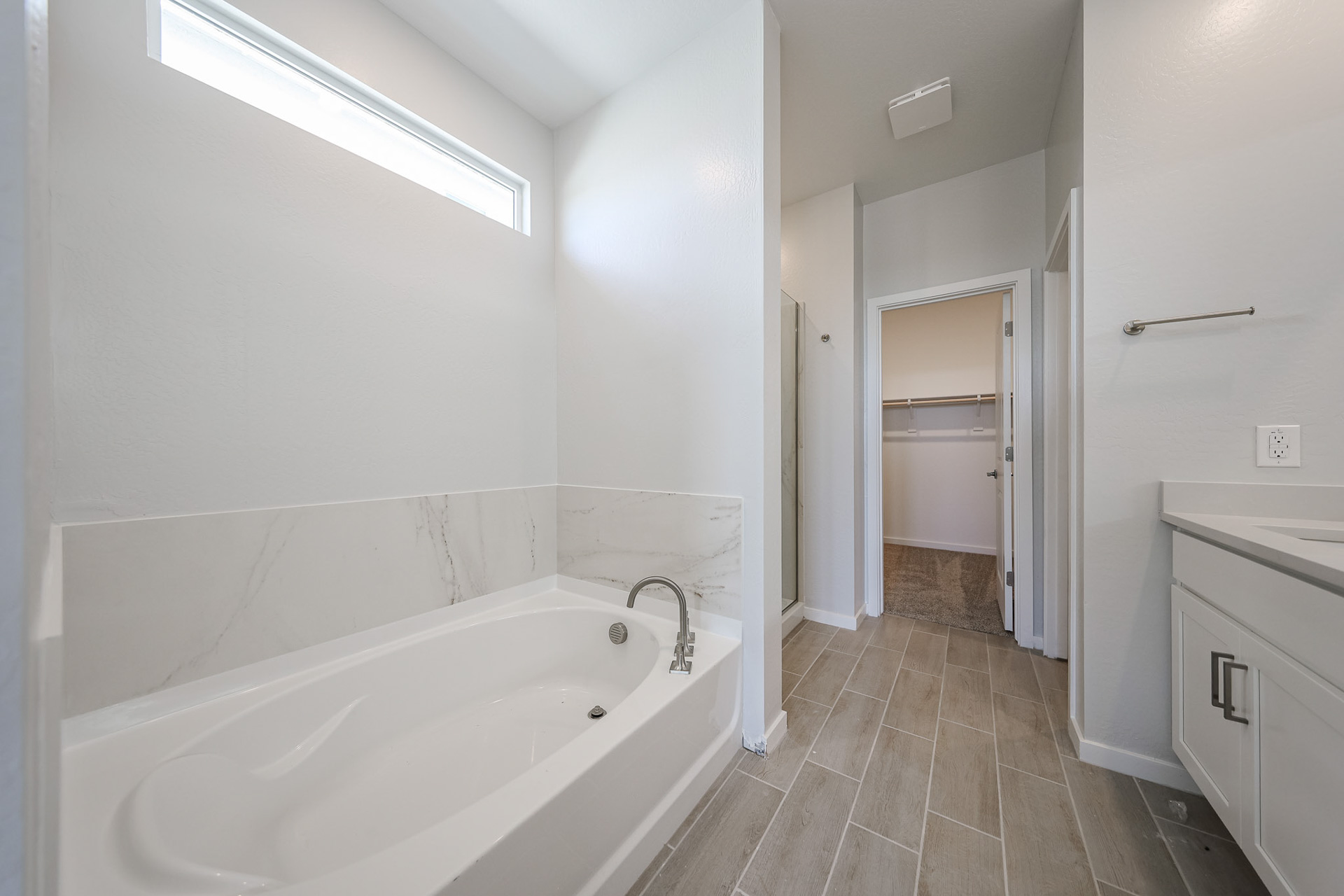 A bathroom with a tub and sink.