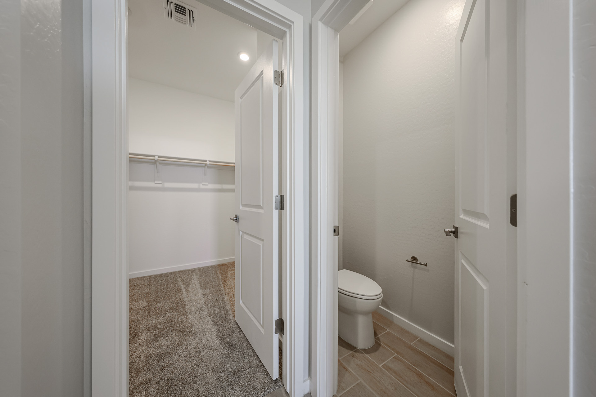 A bathroom with white doors.