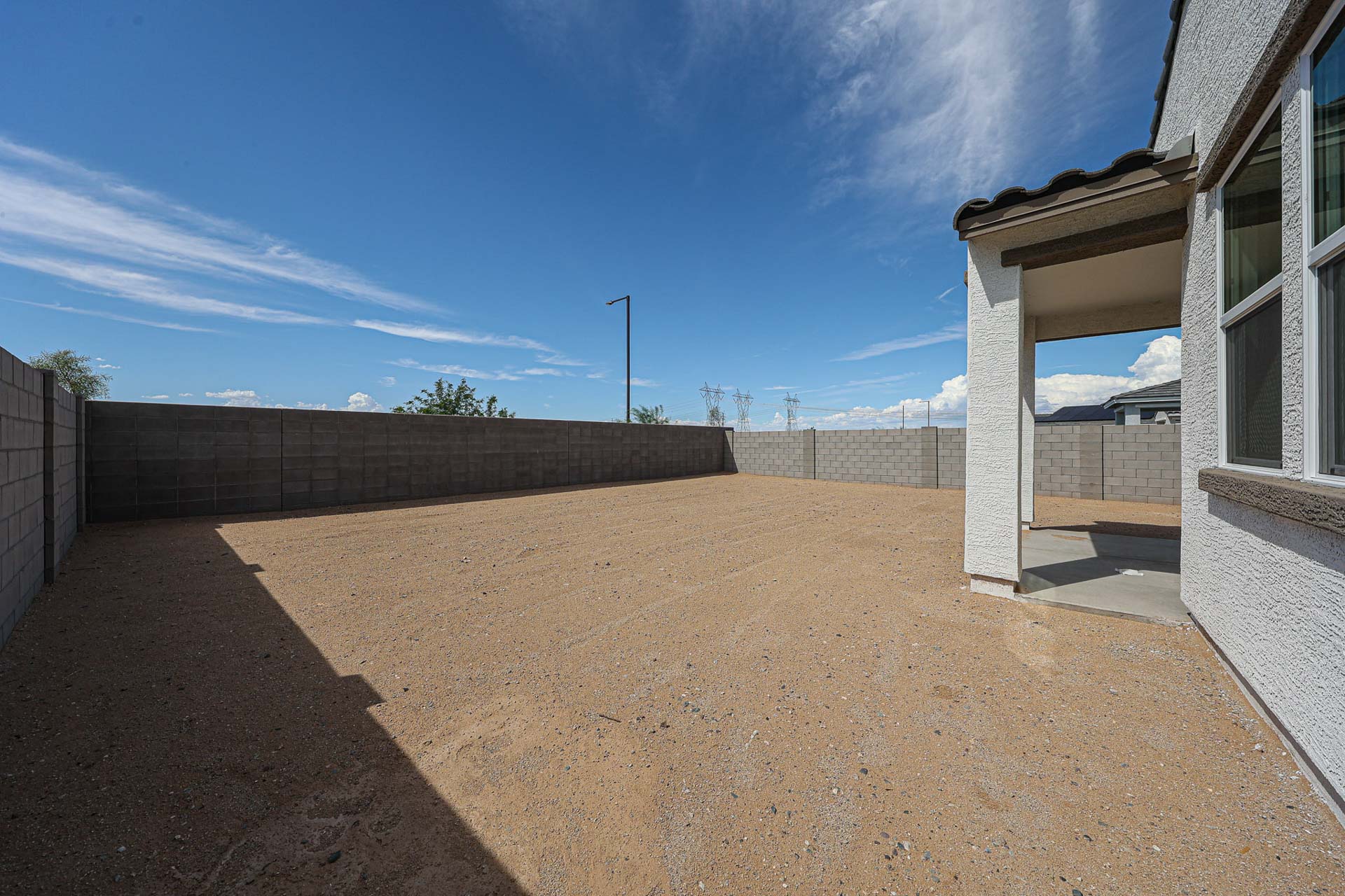 A dirt road between buildings.