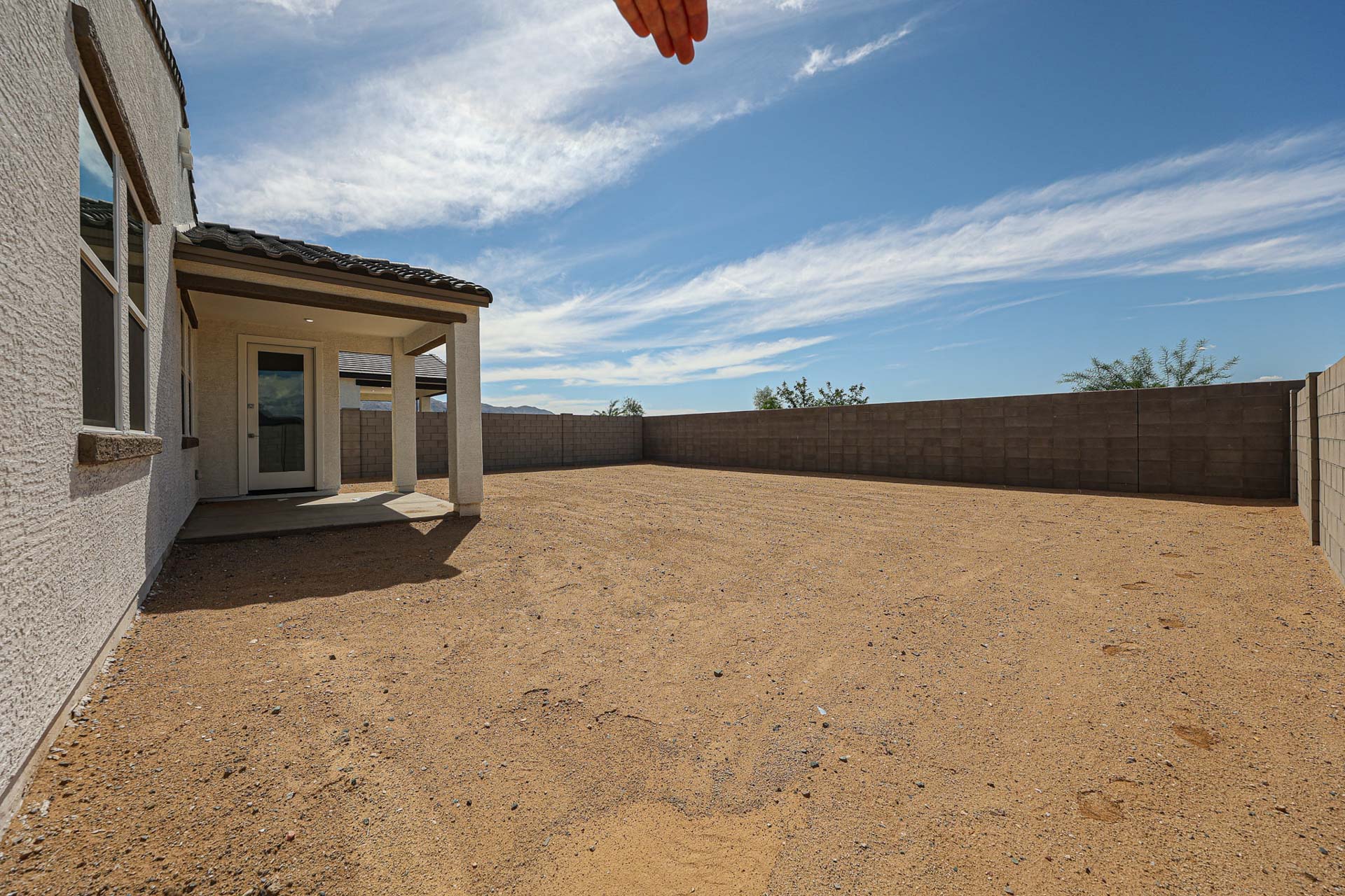 A dirt road between buildings.