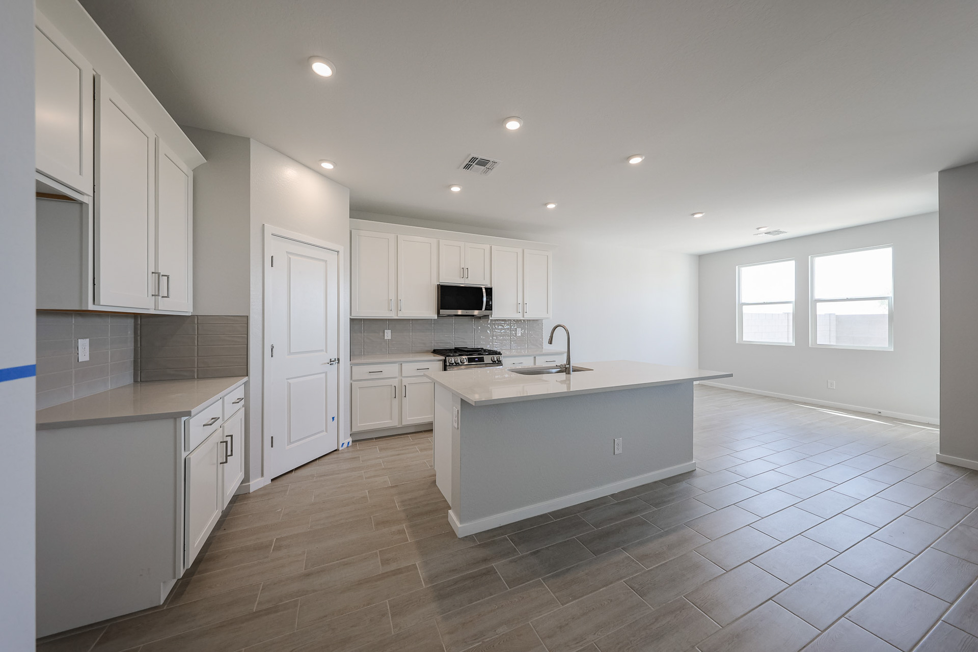 A kitchen with white cabinets.