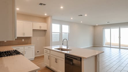 A kitchen with white cabinets.
