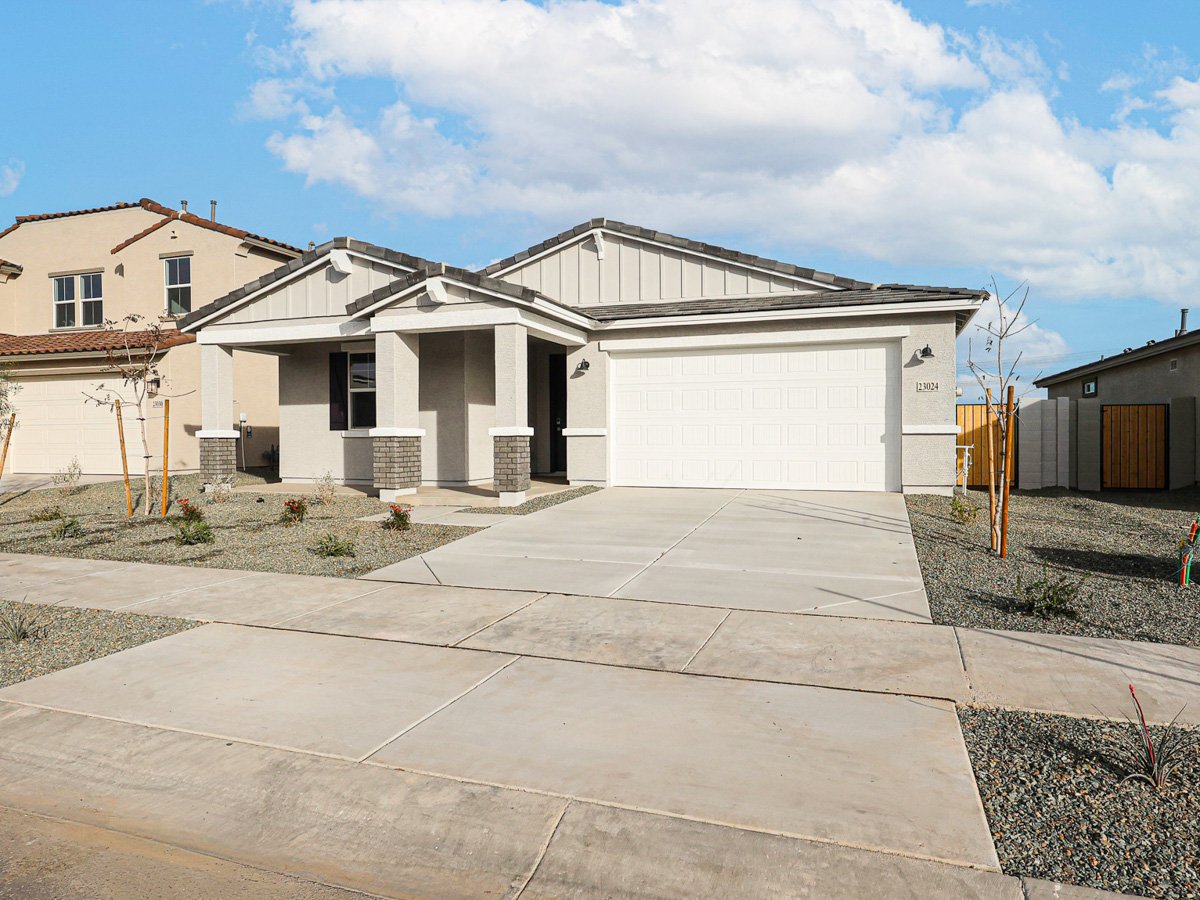 A white house with a garage.