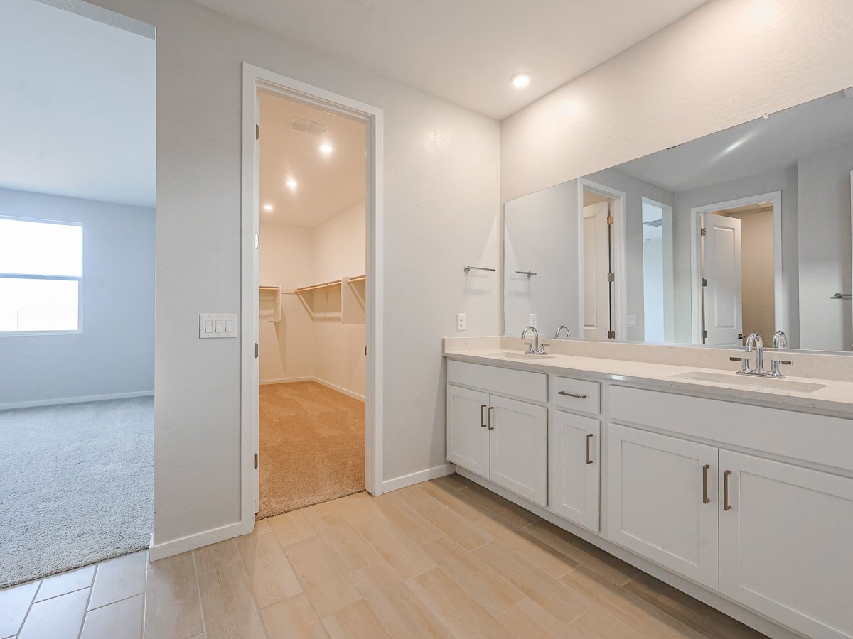 A bathroom with a large mirror.