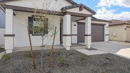 A building with a tree in front.