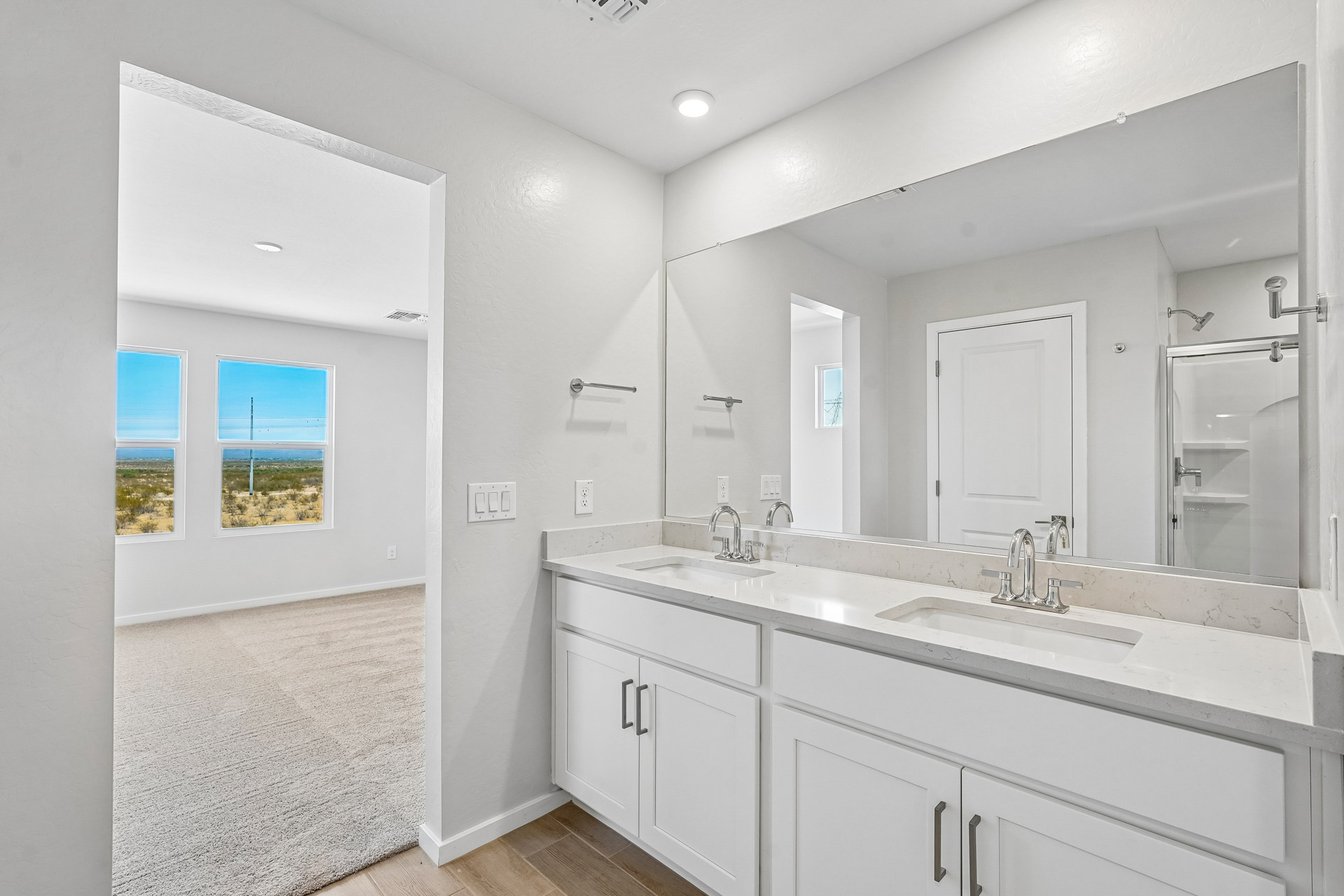 A bathroom with a large mirror.