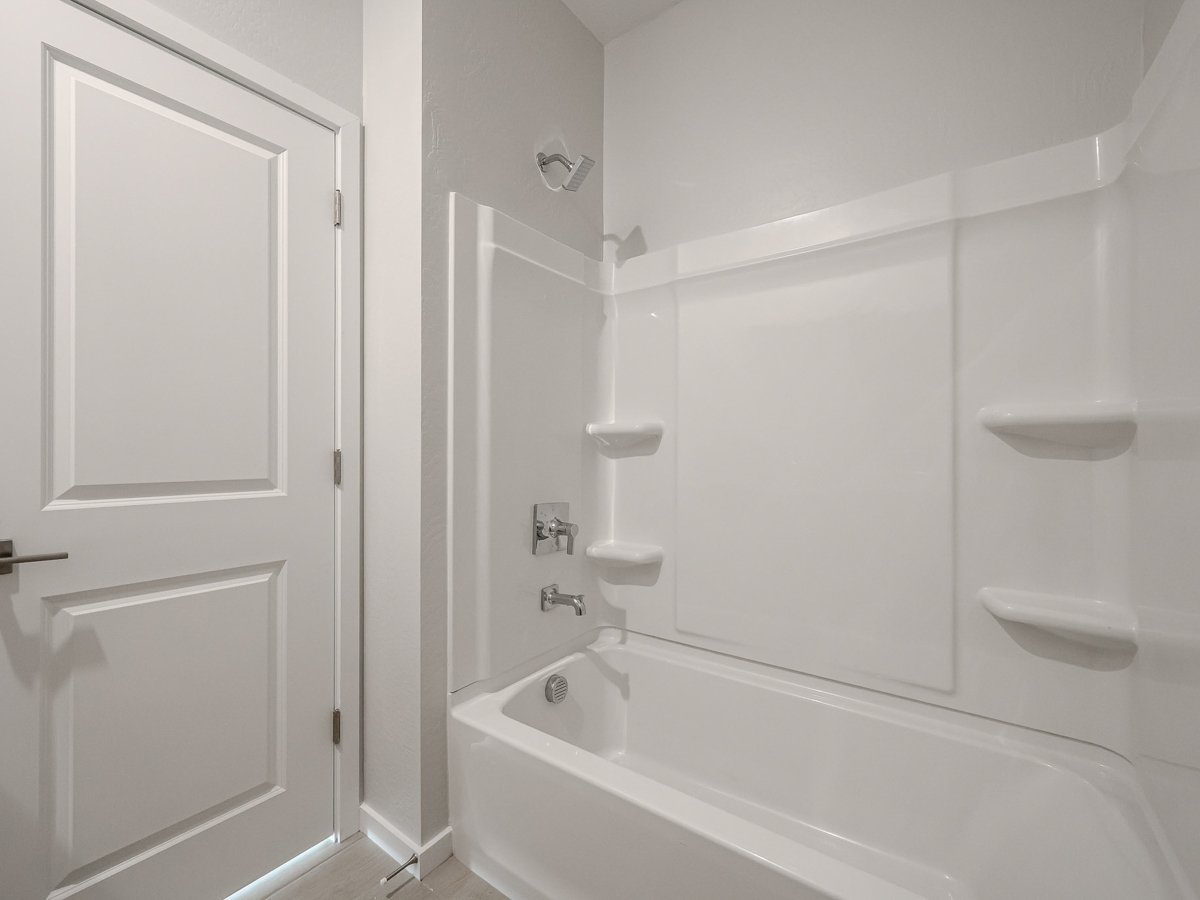 A bathroom with a bathtub sink and toilet.