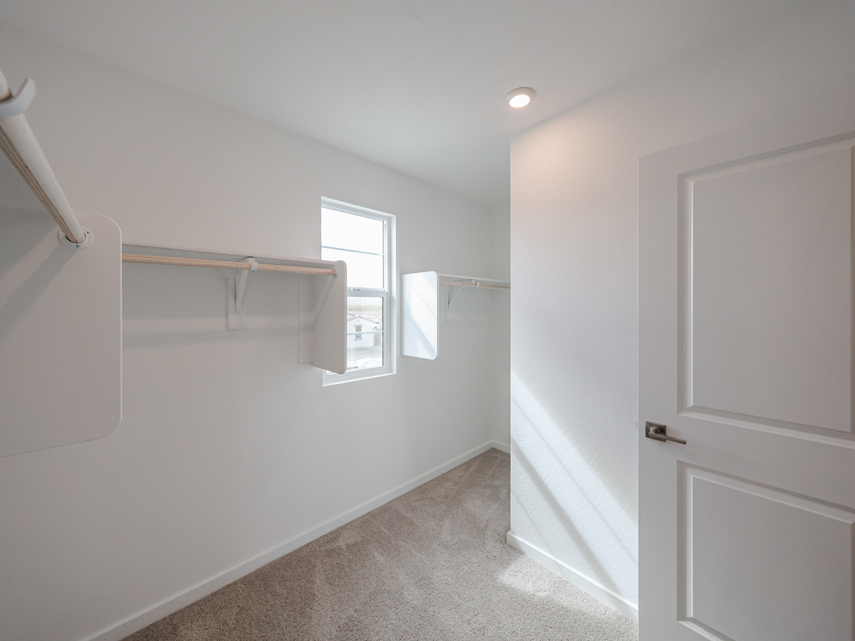 A room with white walls and a window.