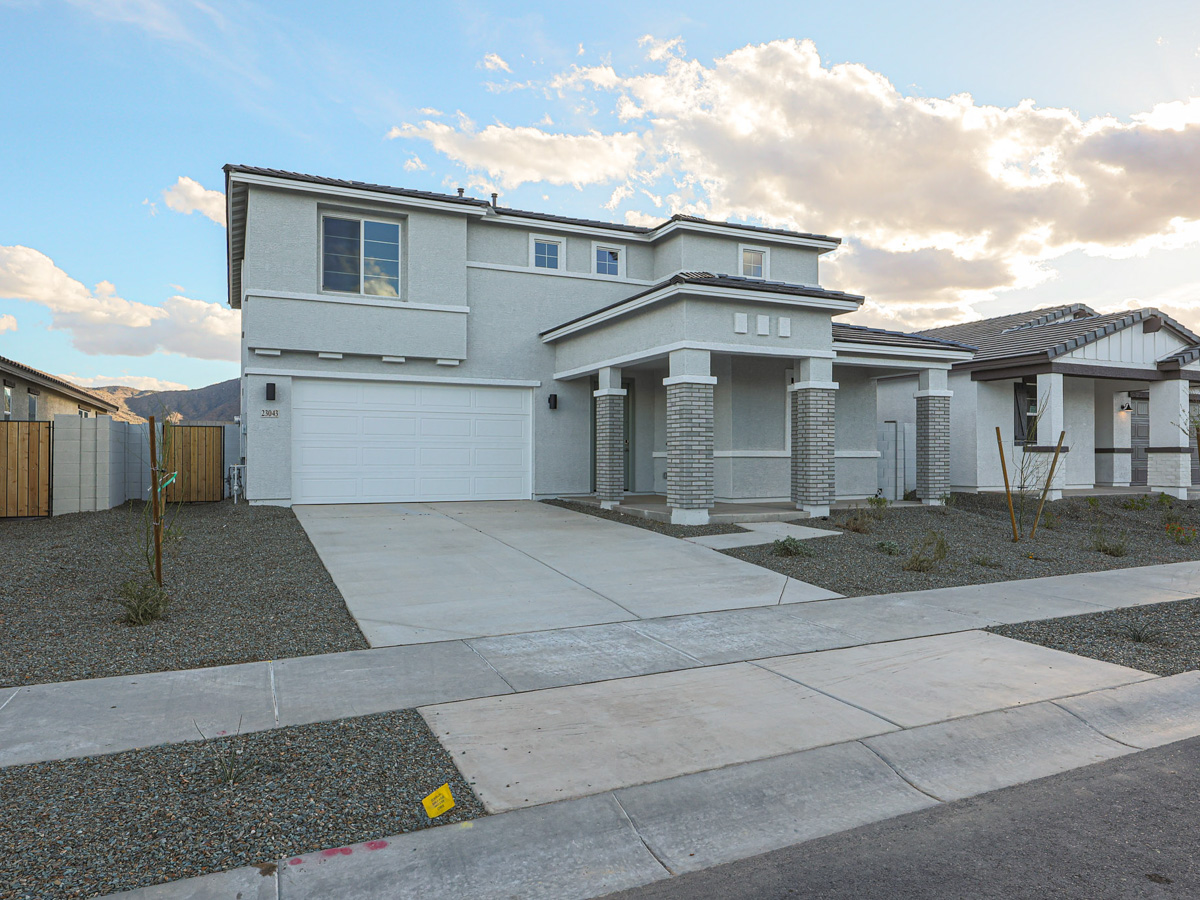 A white house with a driveway.