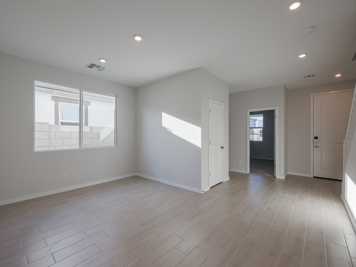 A room with a wood floor and white walls.