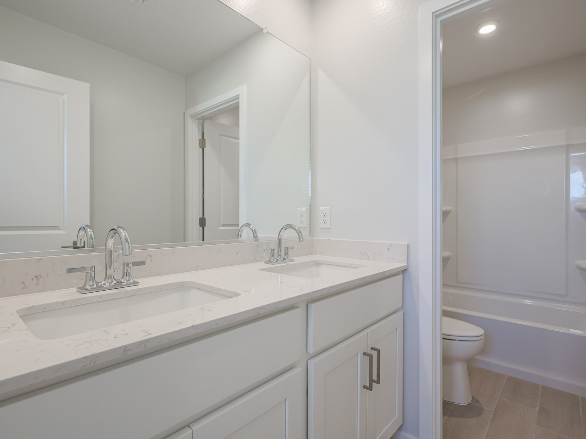 A bathroom with a sink toilet and bathtub.