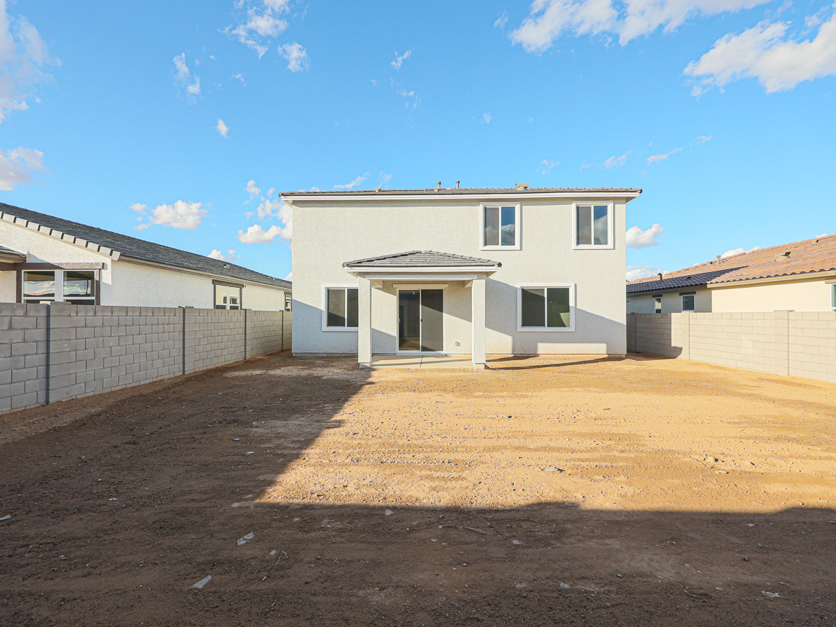 A building with a dirt lot.