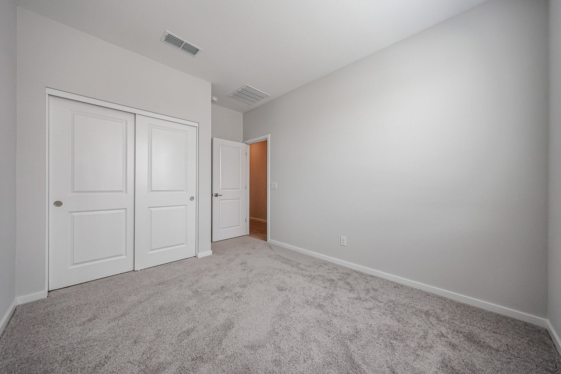 A hallway with white doors.