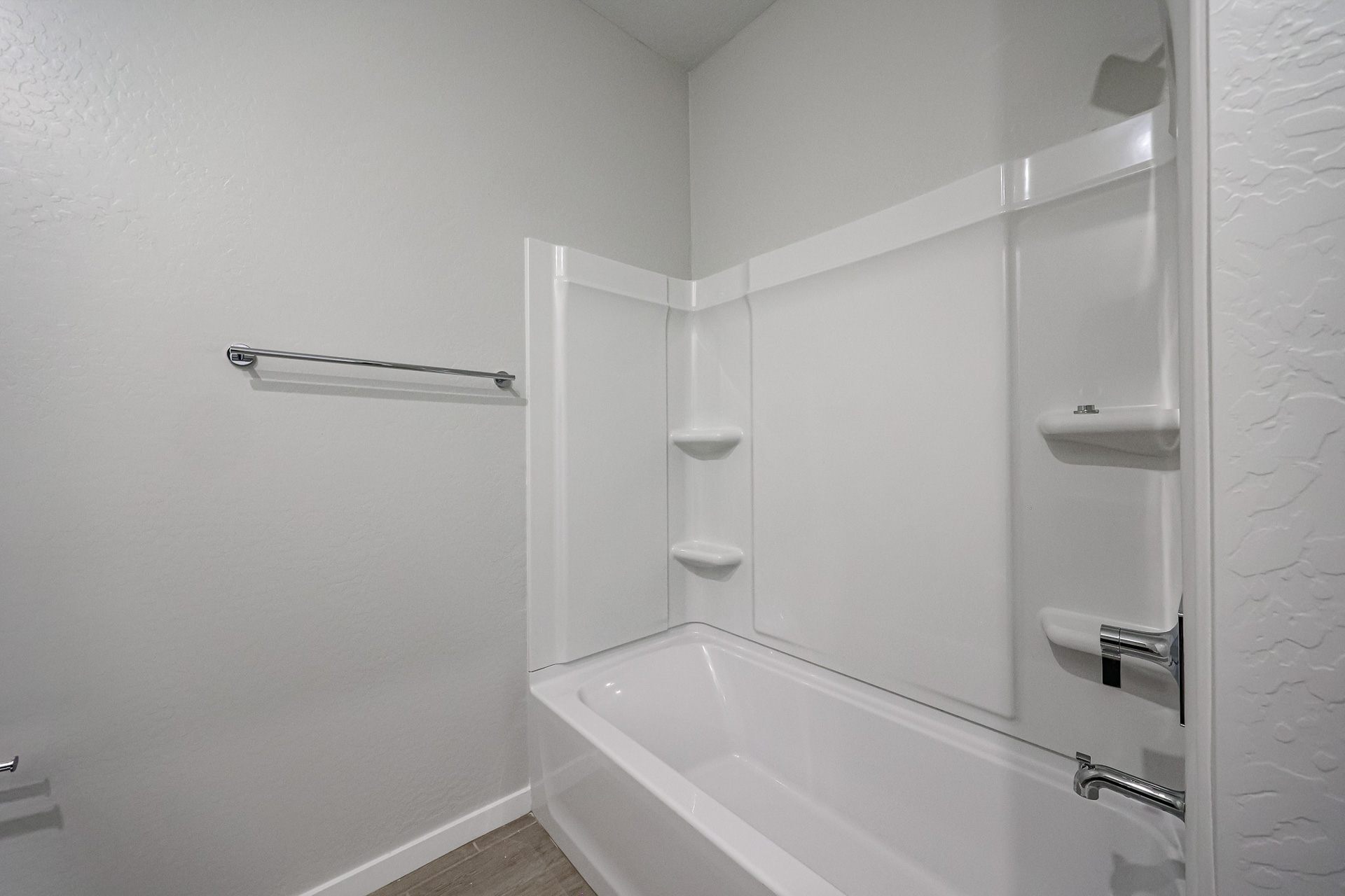 A bathtub in a bathroom.