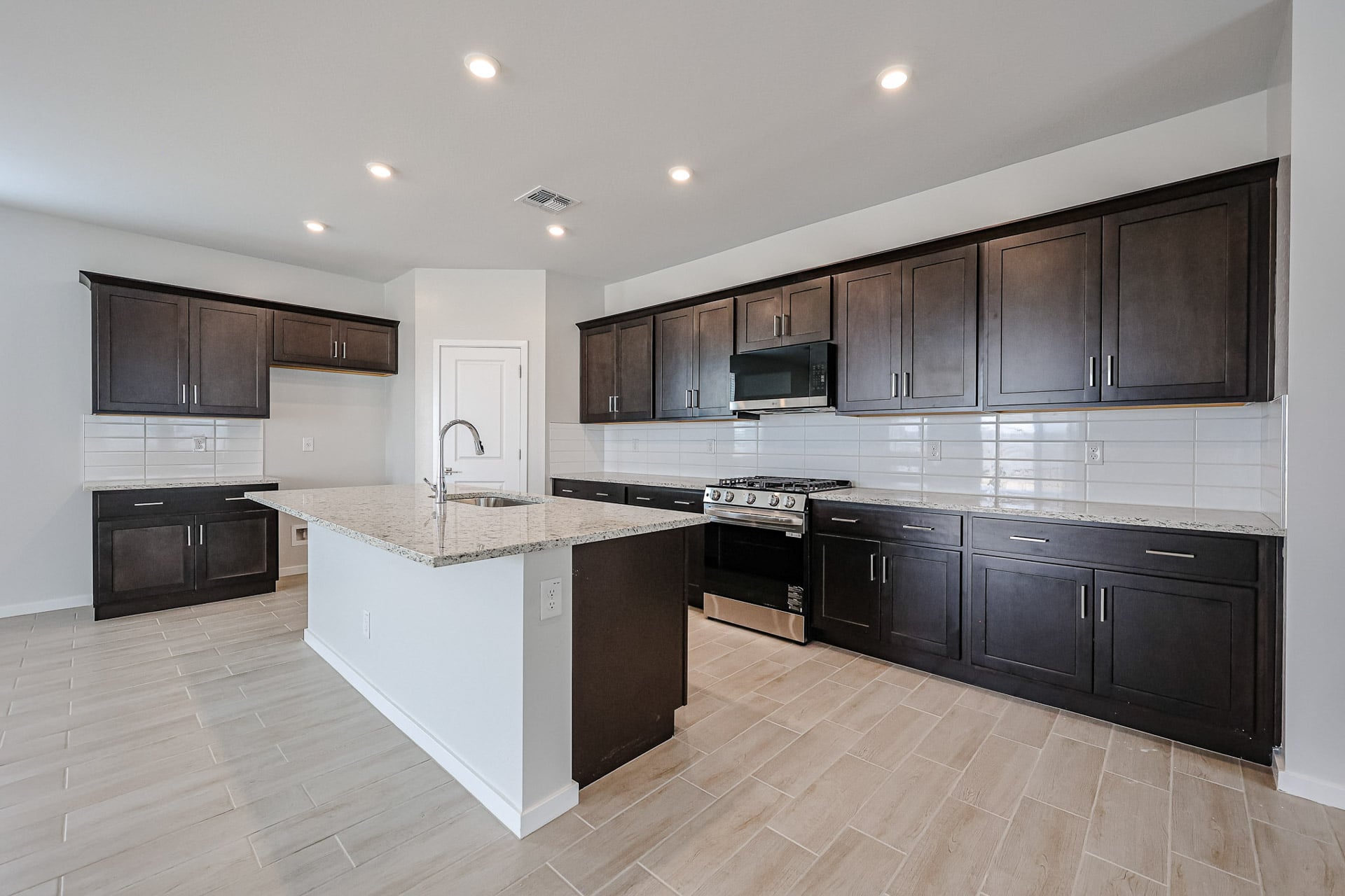A kitchen with black cabinets.