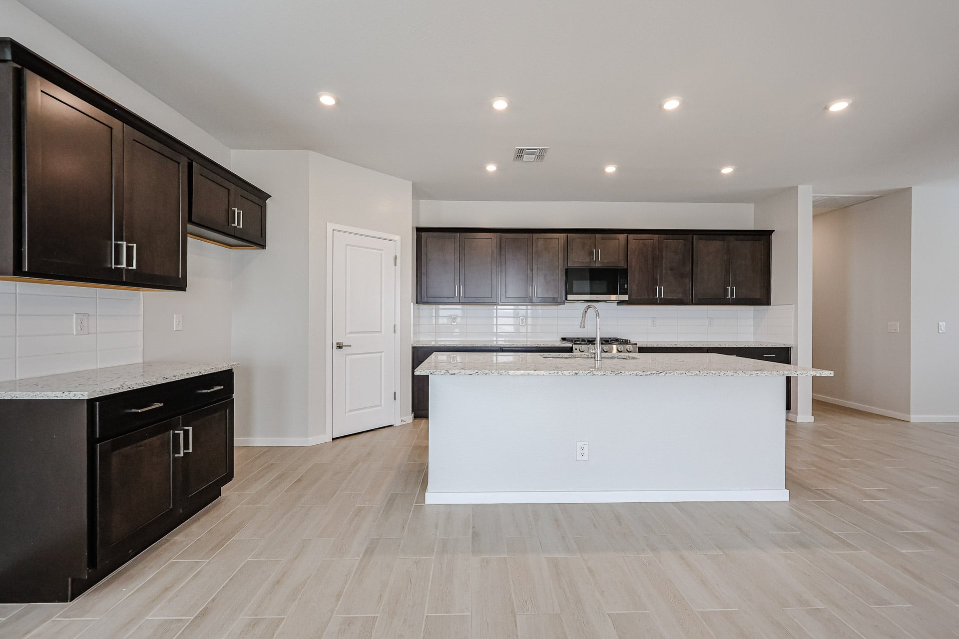 A kitchen with wooden cabinets.