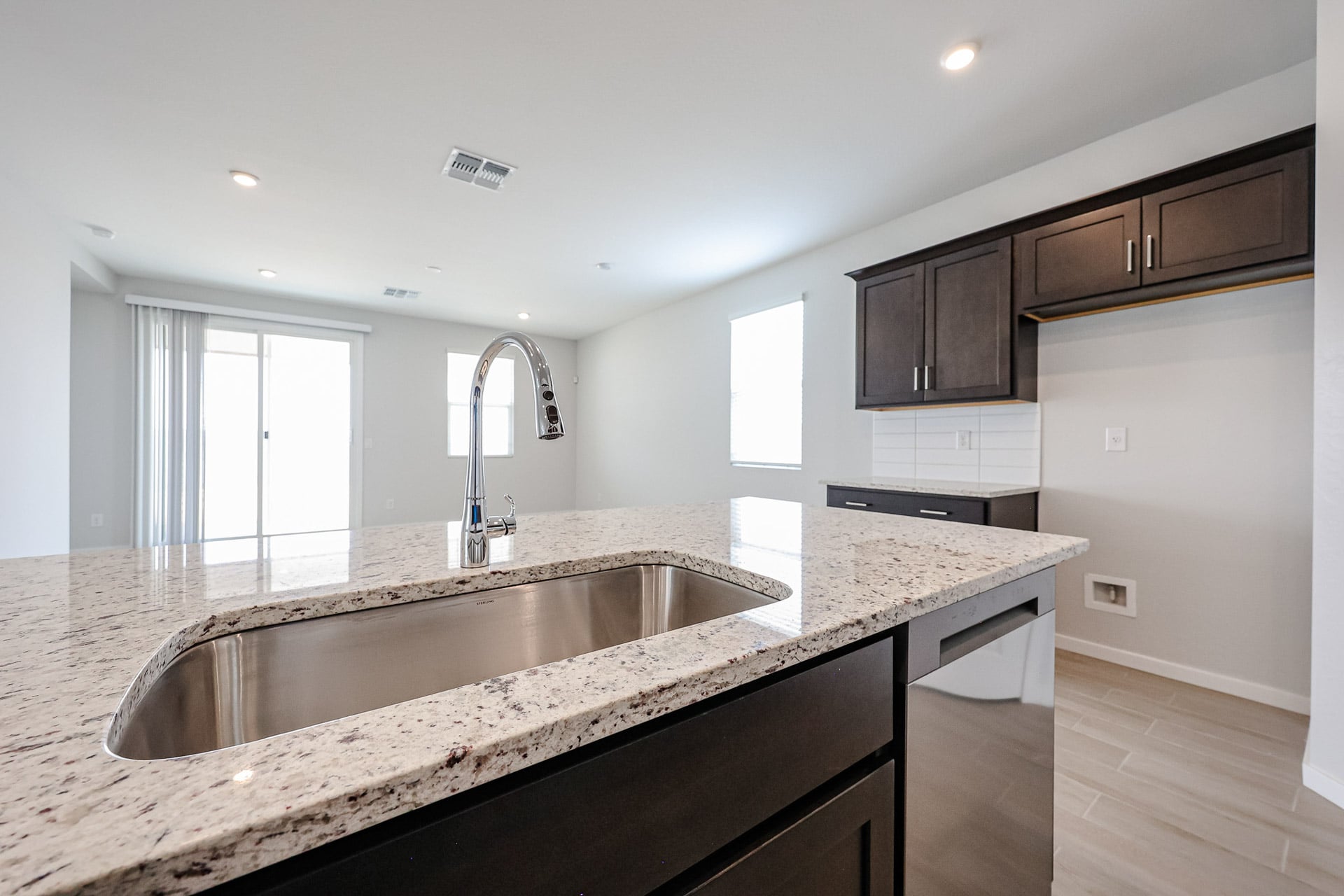 A kitchen with marble counters.
