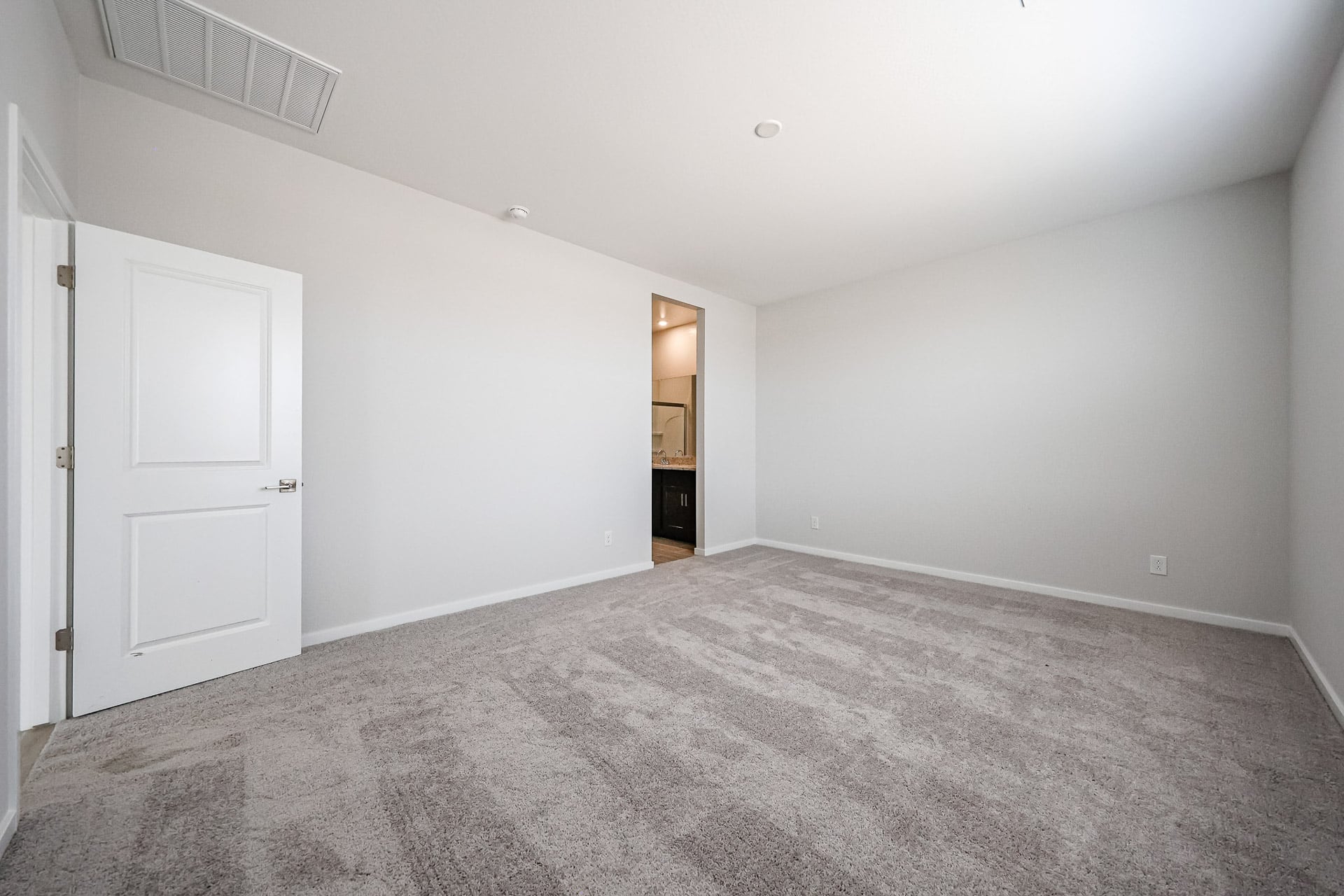 A hallway with white doors.