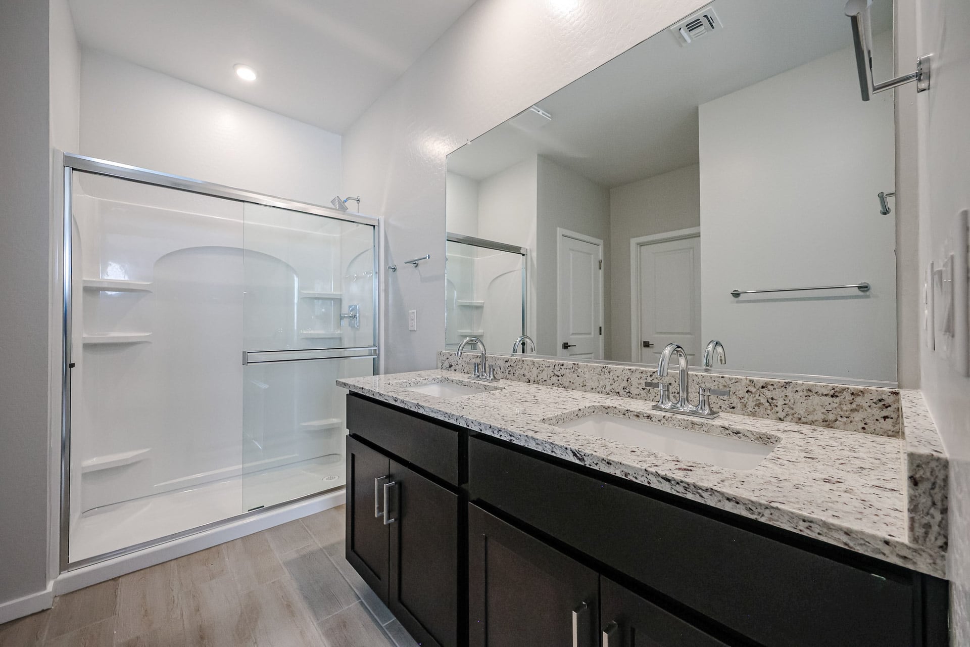 A bathroom with a large mirror.