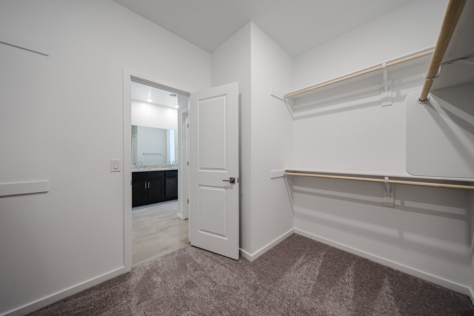A white room with a white wall and a mirror.