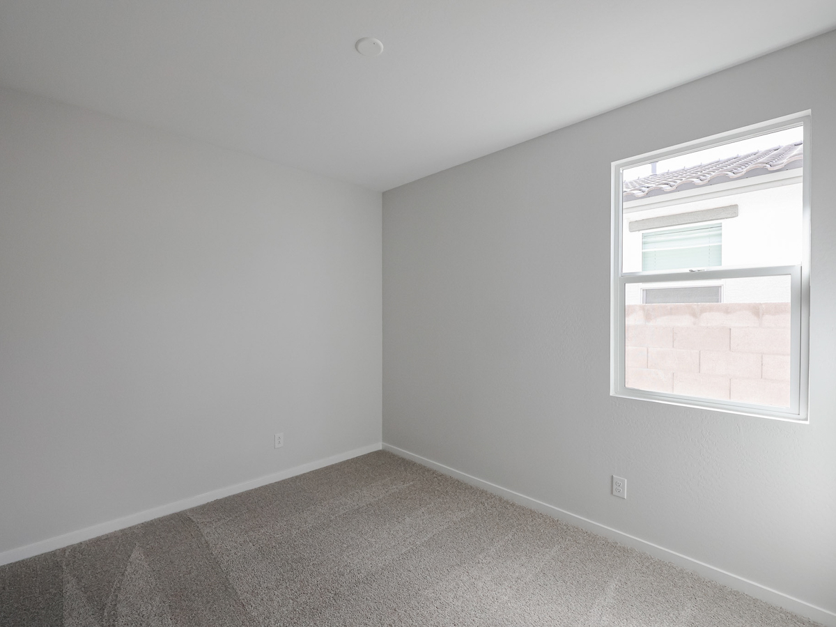 A room with a window and a carpet.