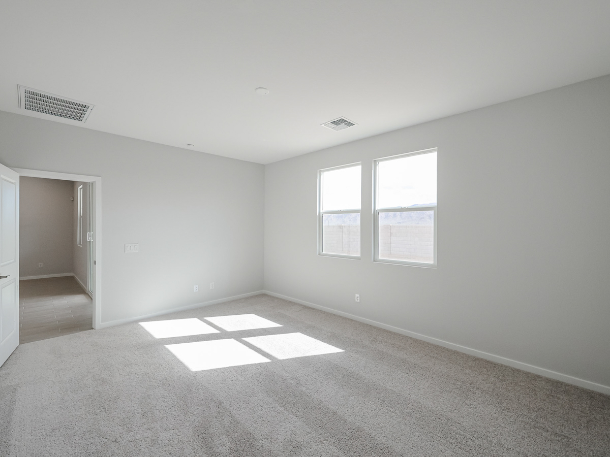 A room with a window and a rug.