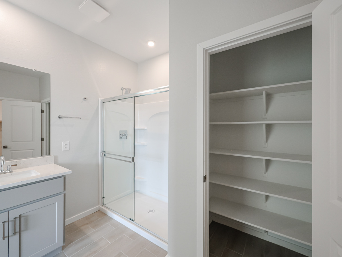 A white bathroom with a glass shower.