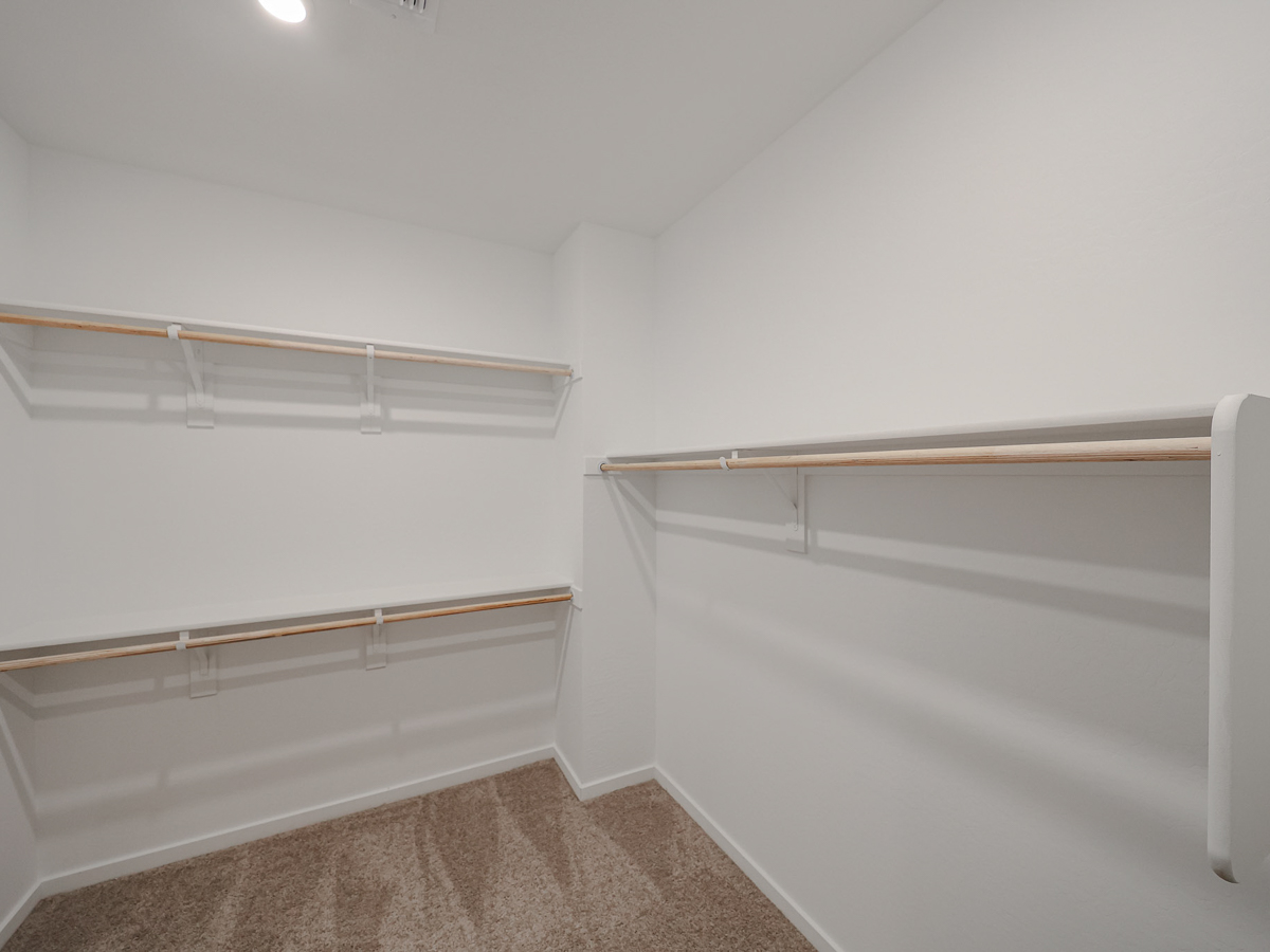 A white wall with a metal railing.