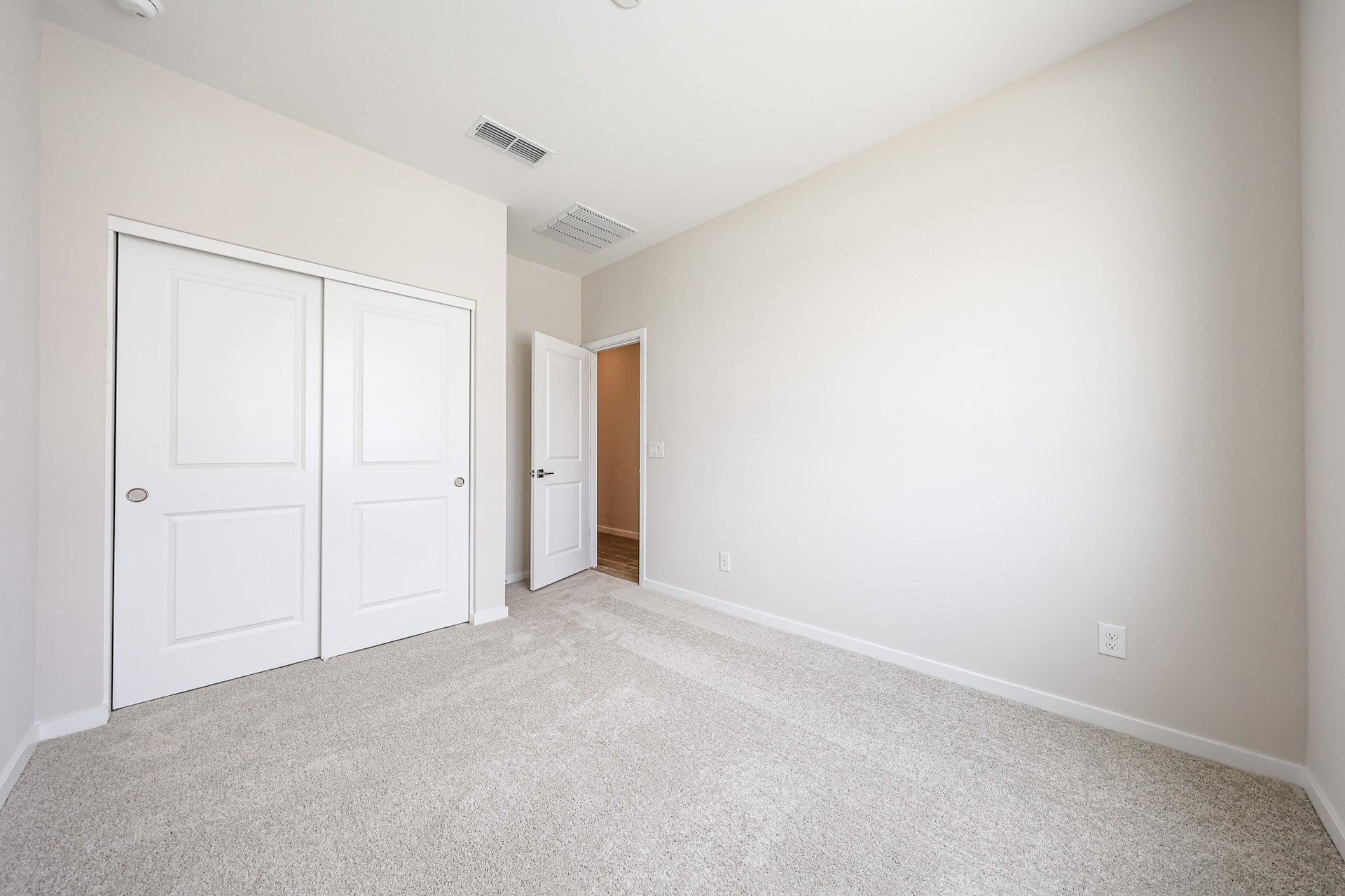 A hallway with white doors.