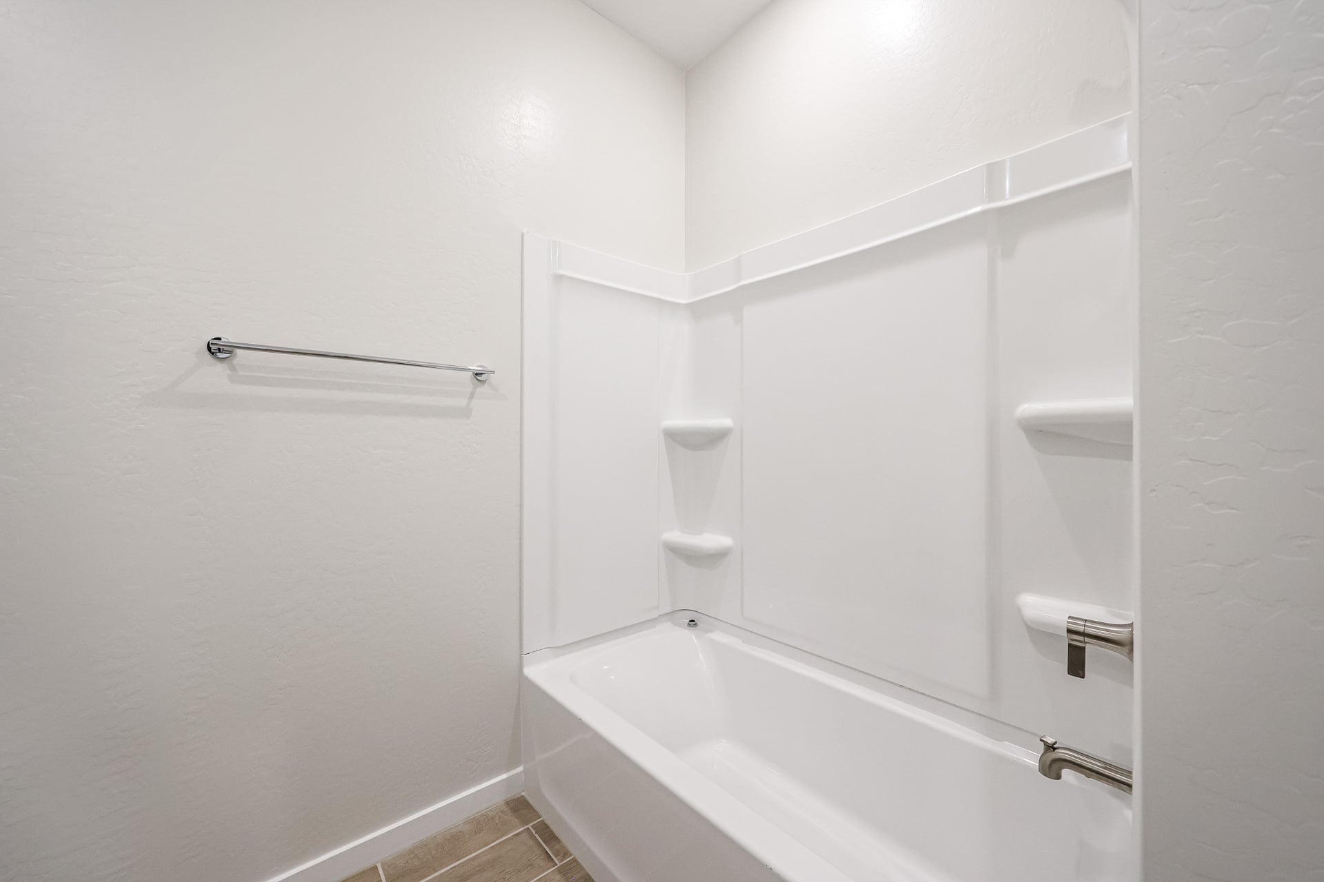 A bathroom with a bathtub and toilet.