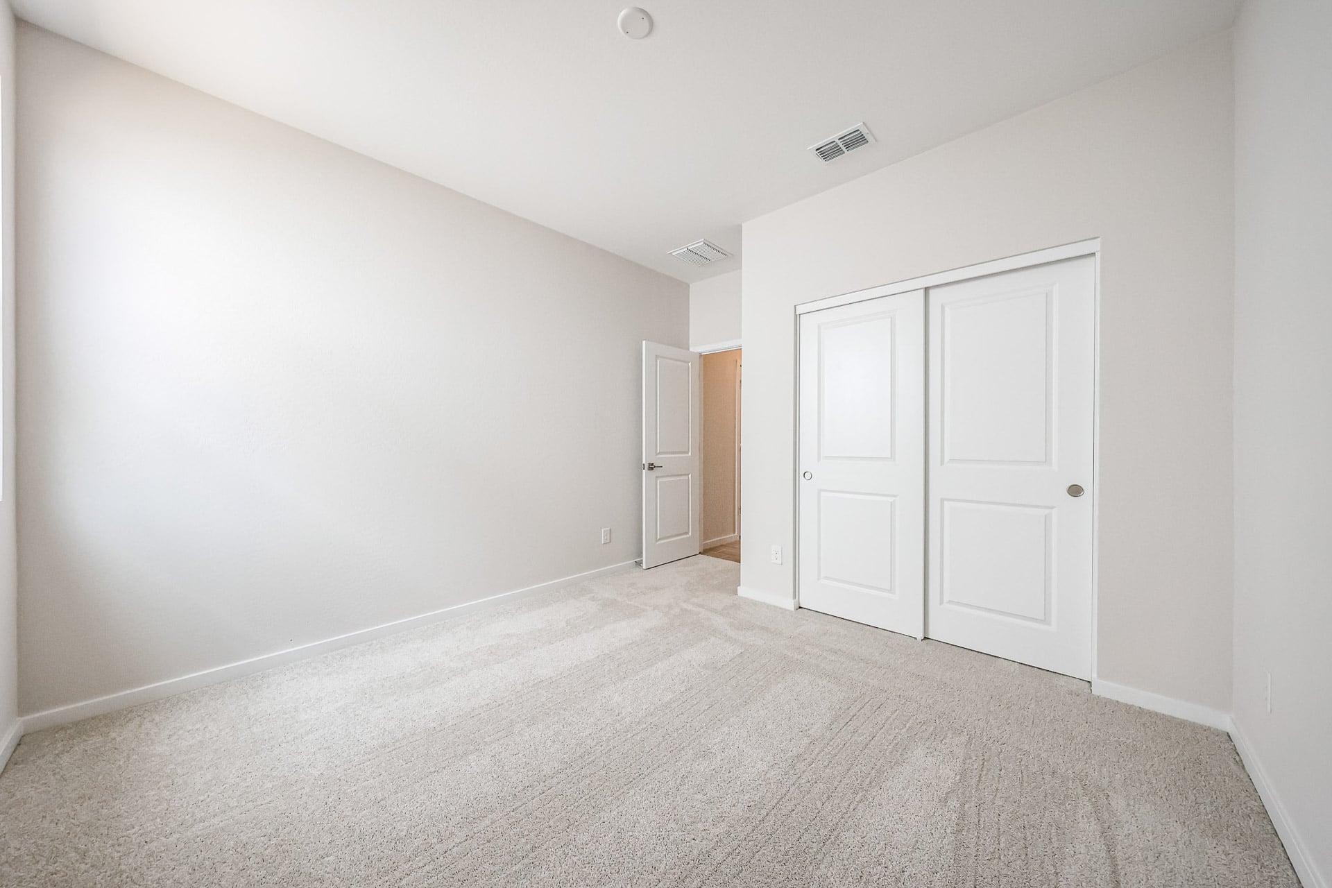 A hallway with white doors.