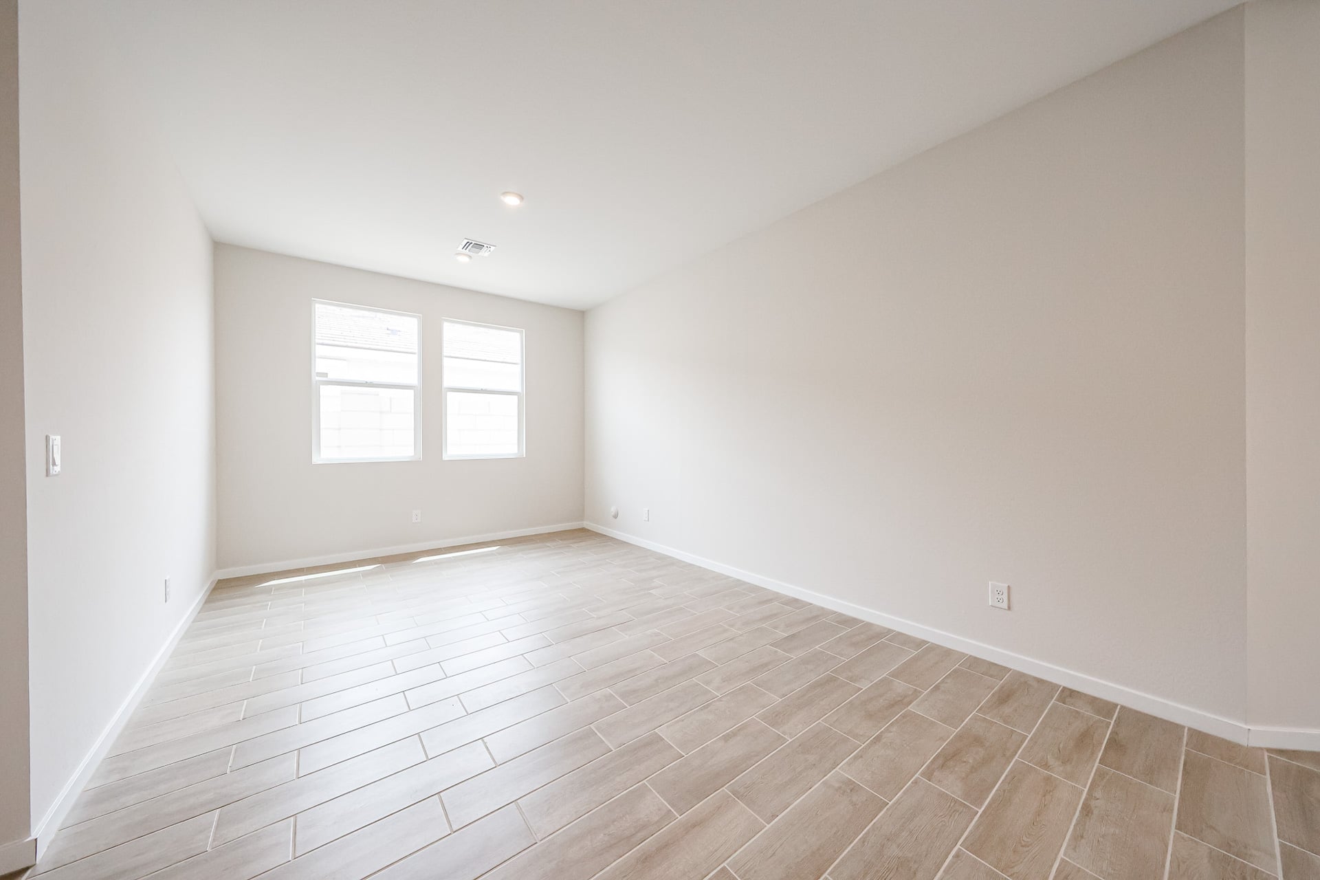 A room with a tile floor and windows.