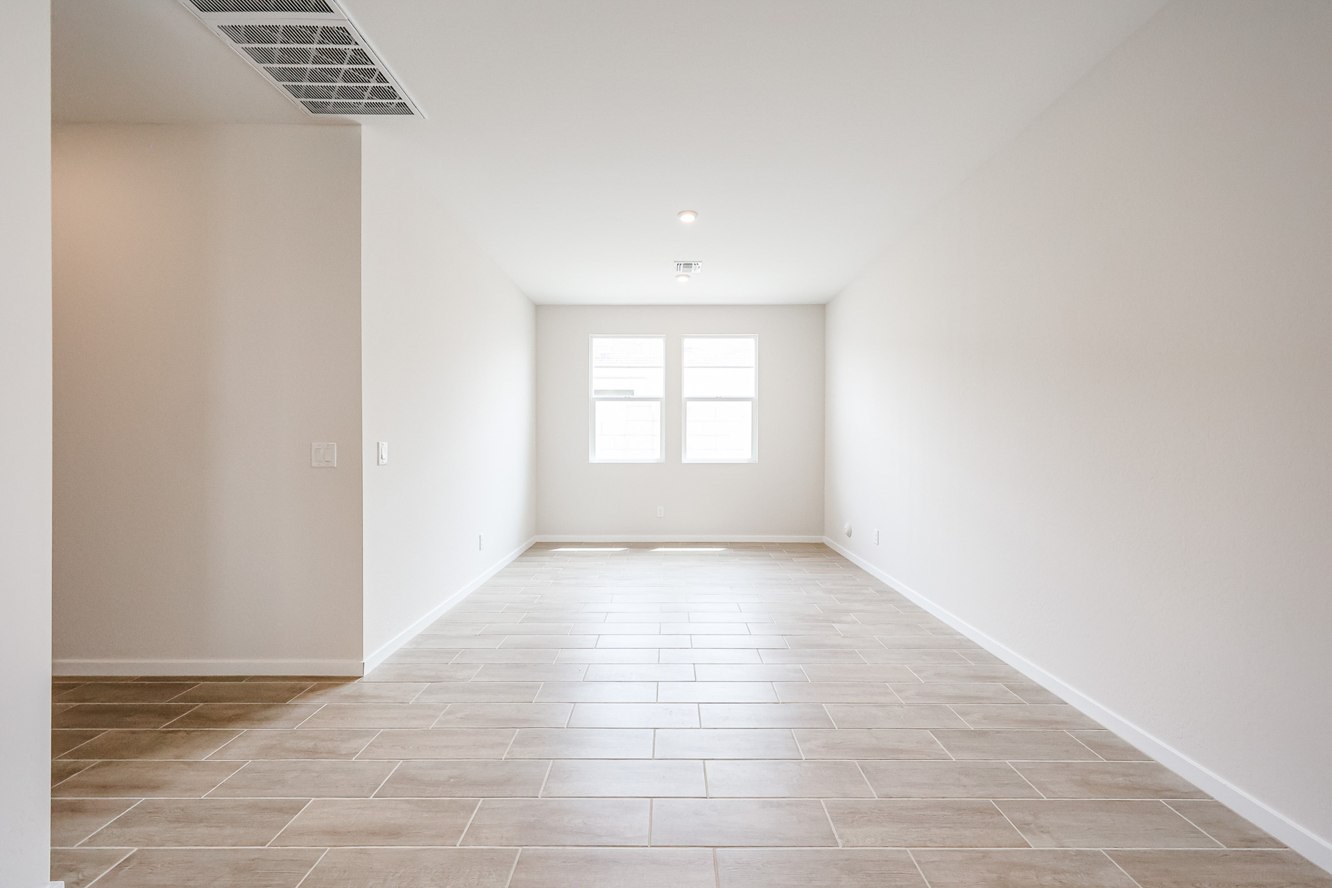 A room with a tile floor and a door.