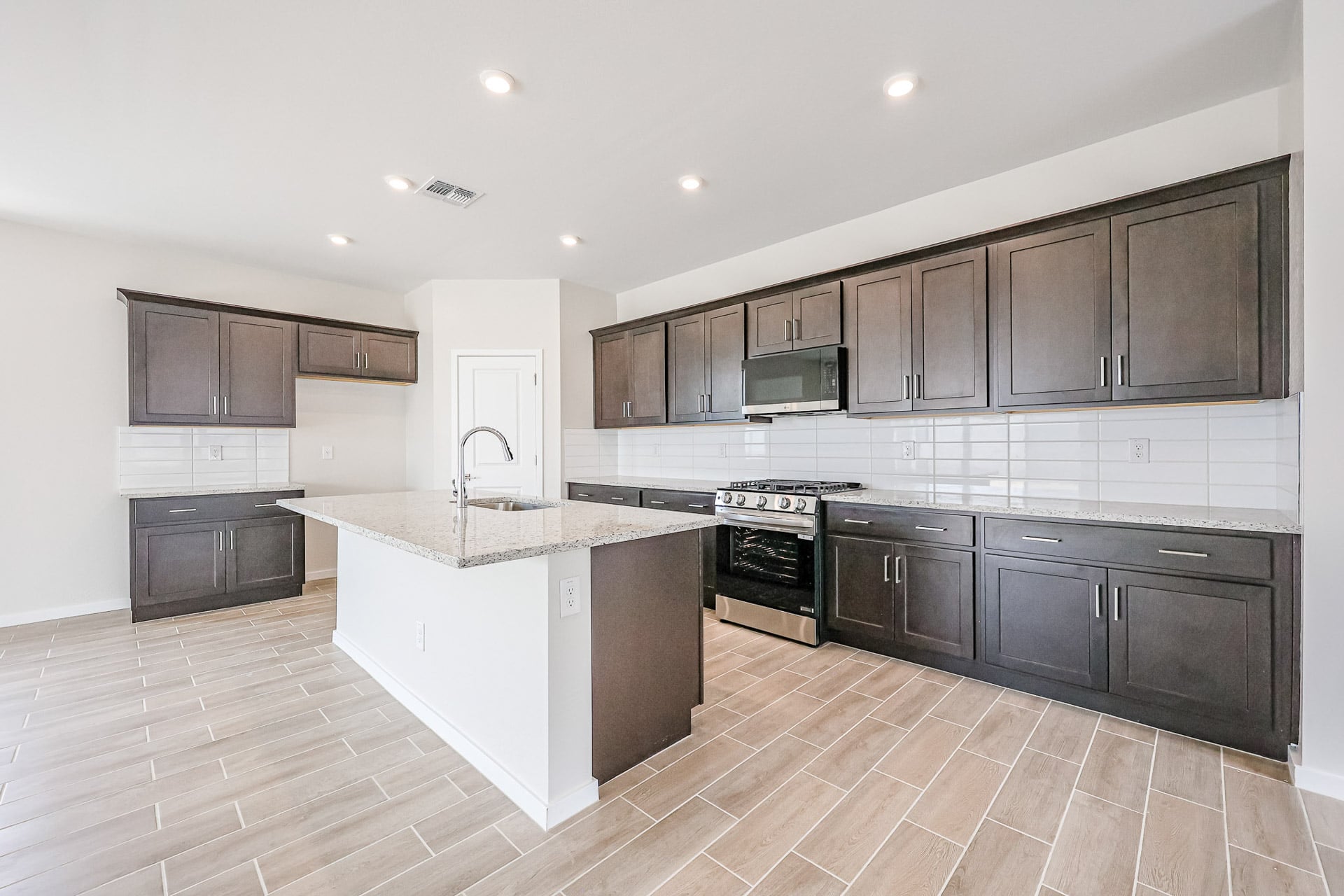 A kitchen with black cabinets.