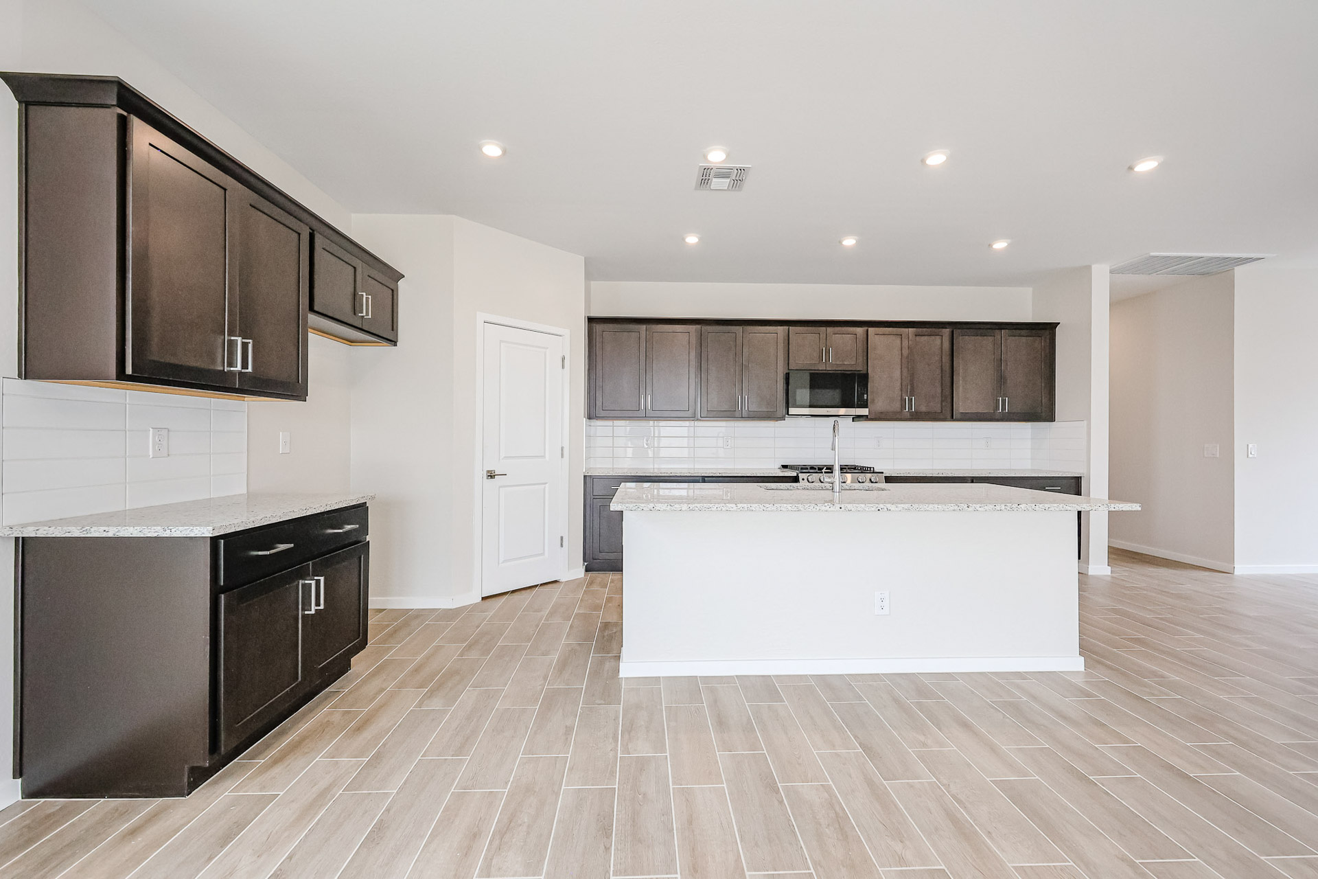 A kitchen with wooden cabinets.