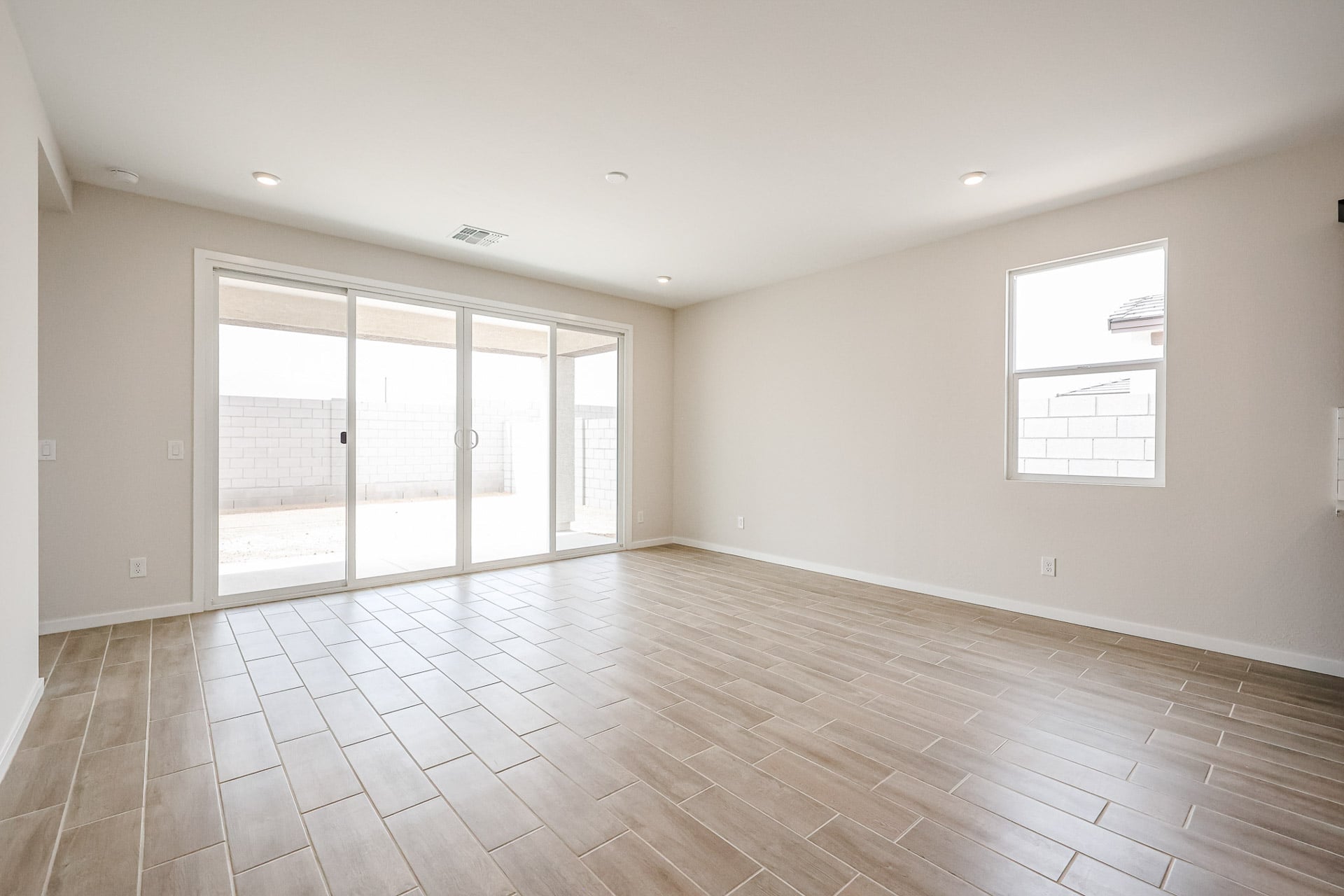 A room with a wood floor and white walls.